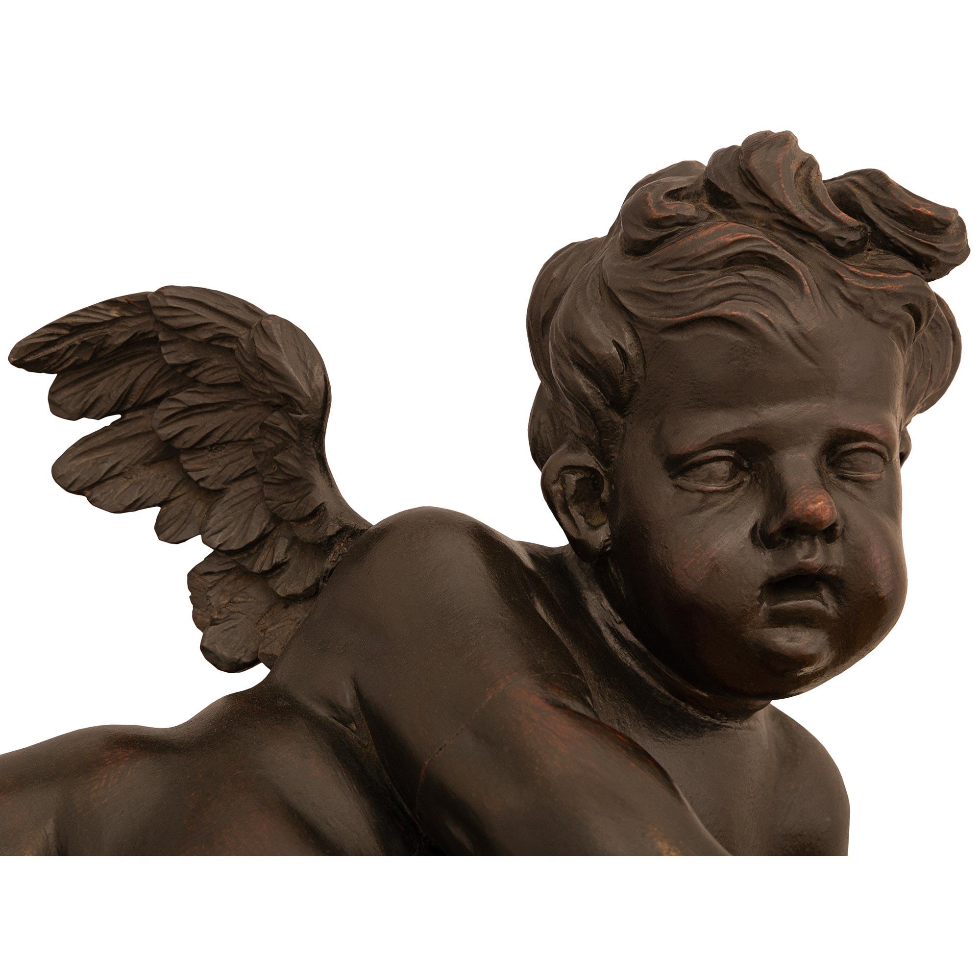 18th Century and Earlier Italian 17th Century Baroque Period Giltwood And Patinated Wood Putti Statue For Sale