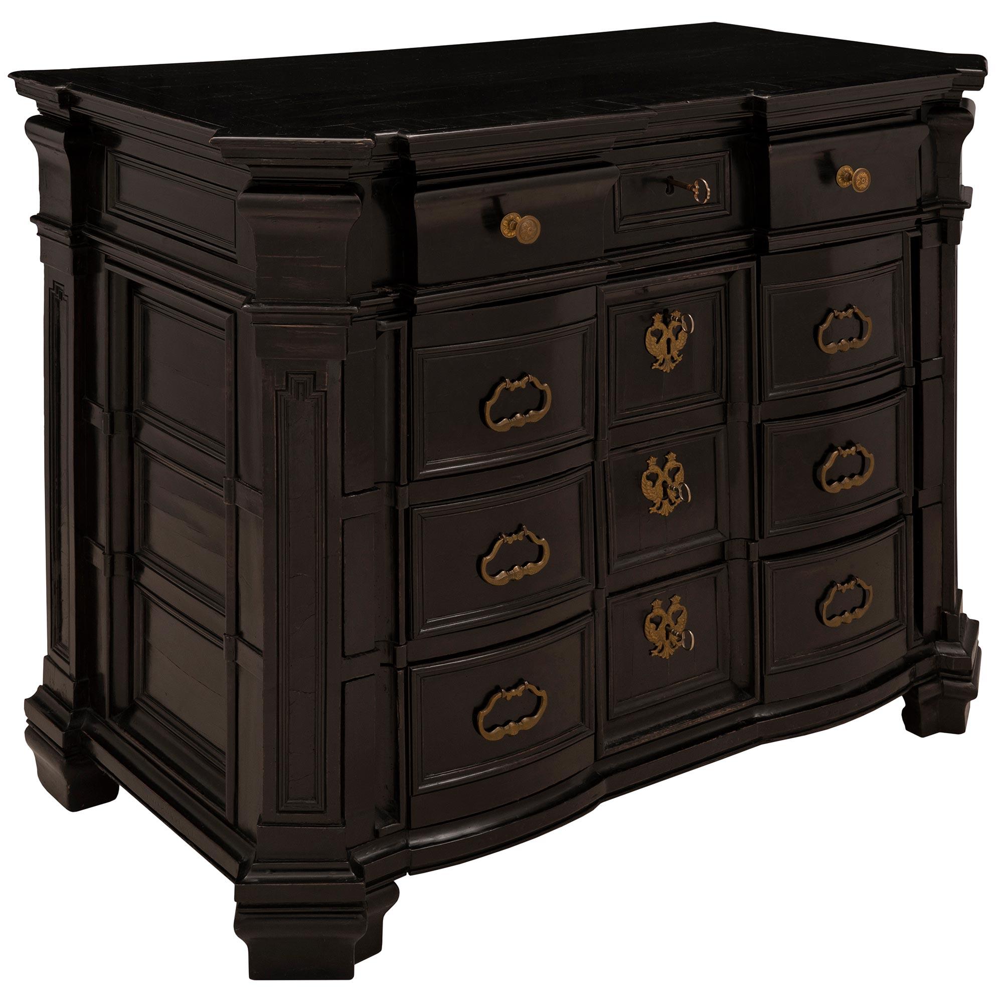An exceptional and important 17th century, circa 1680, ebonized fruitwood commode from Milan, Italy. The commode with its unique linear and architectural lines throughout has an arbalette shaped front with cut-angle corners. The moulded border