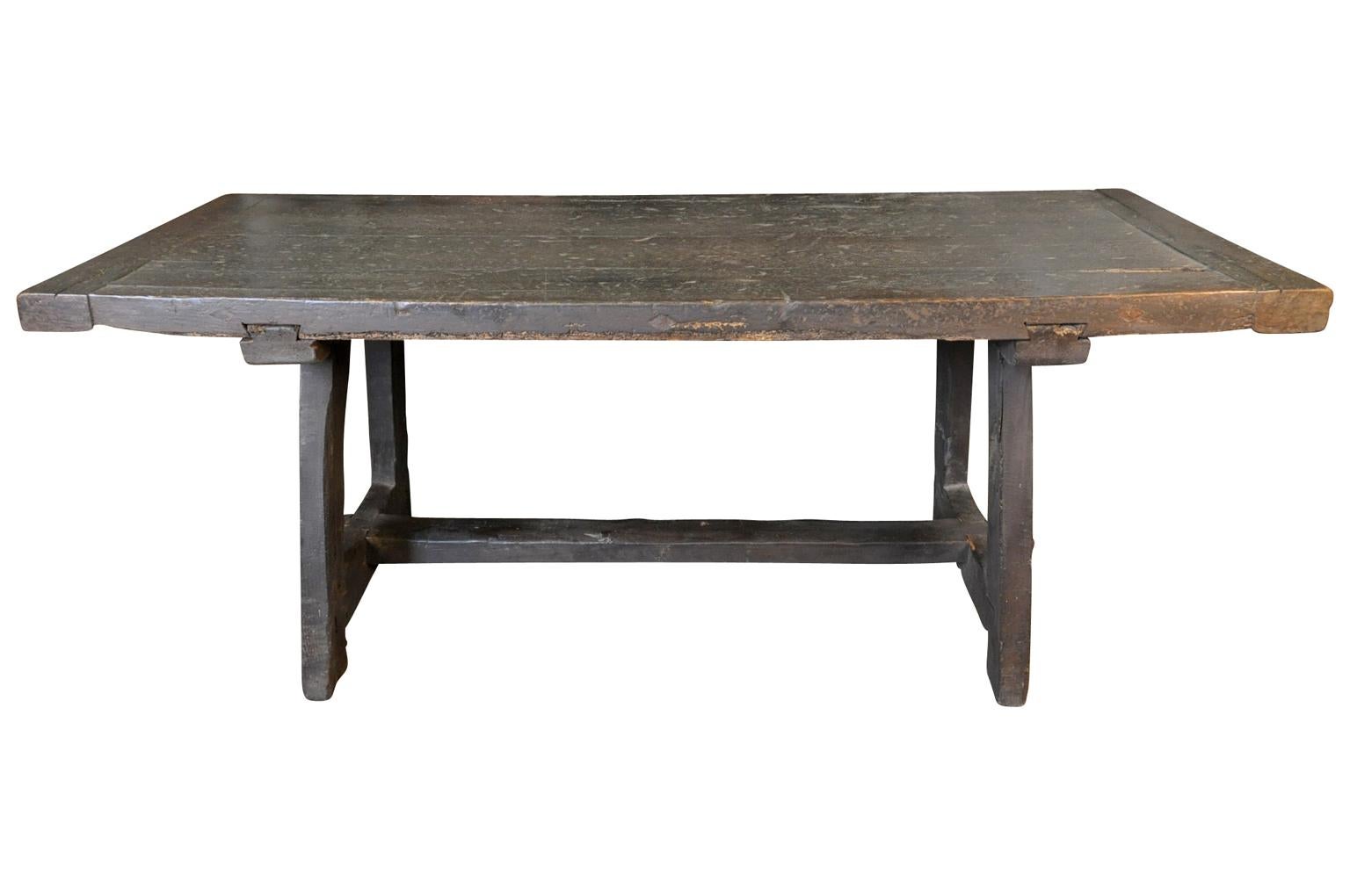 A very beautiful, Primitive farm table - trestle table from Northern Italy. Wonderfully and sturdily constructed from darkly stained massive oak. Wonderful not only as a dining table, but as a console, writing table or serving table as well.