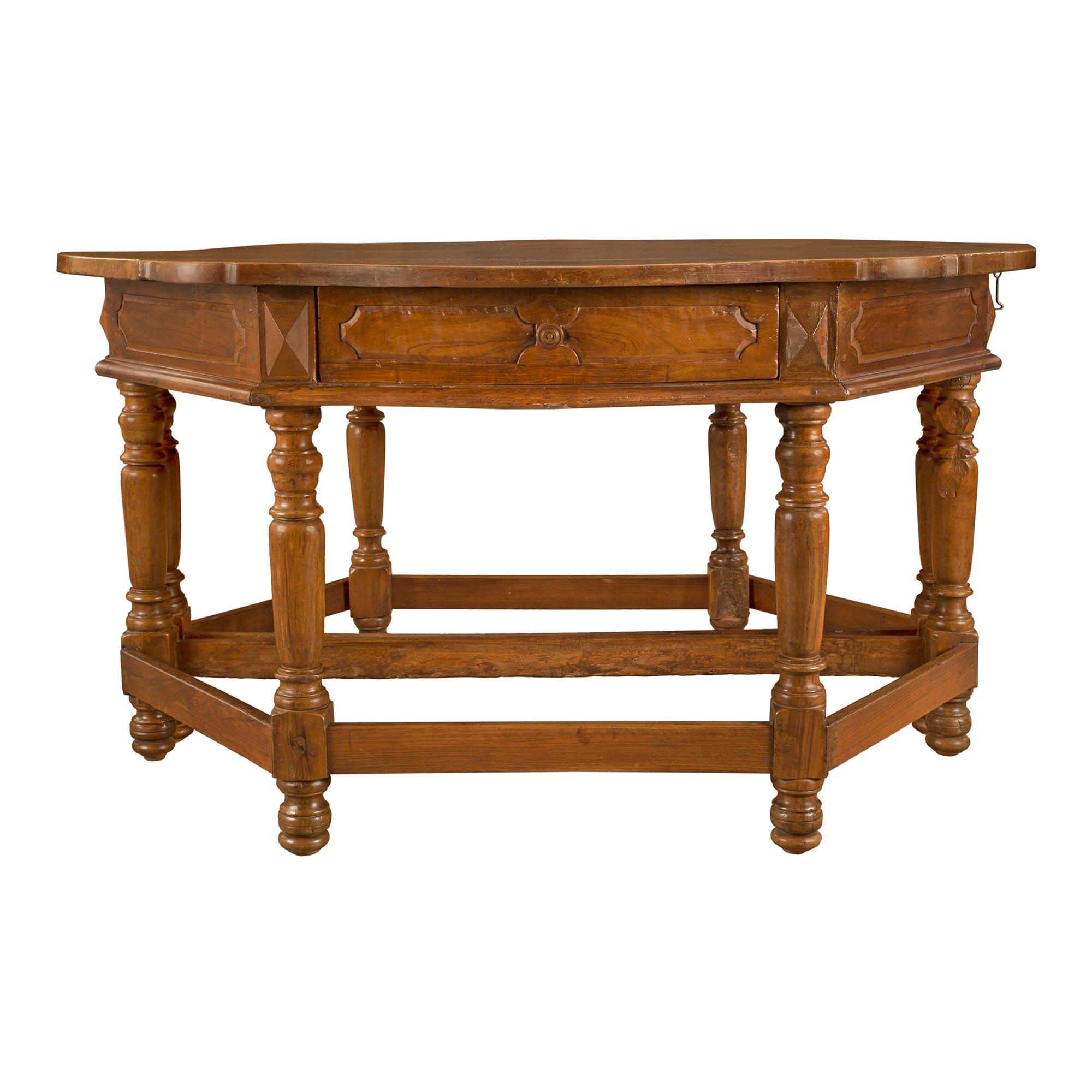 A very handsome pair of Italian 17th century Louis XVI period walnut consoles / center table from Tuscany. Each console is raised on four turned legs with topie shaped feet joined by a straight stretcher. The rounded apron has a central drawer with