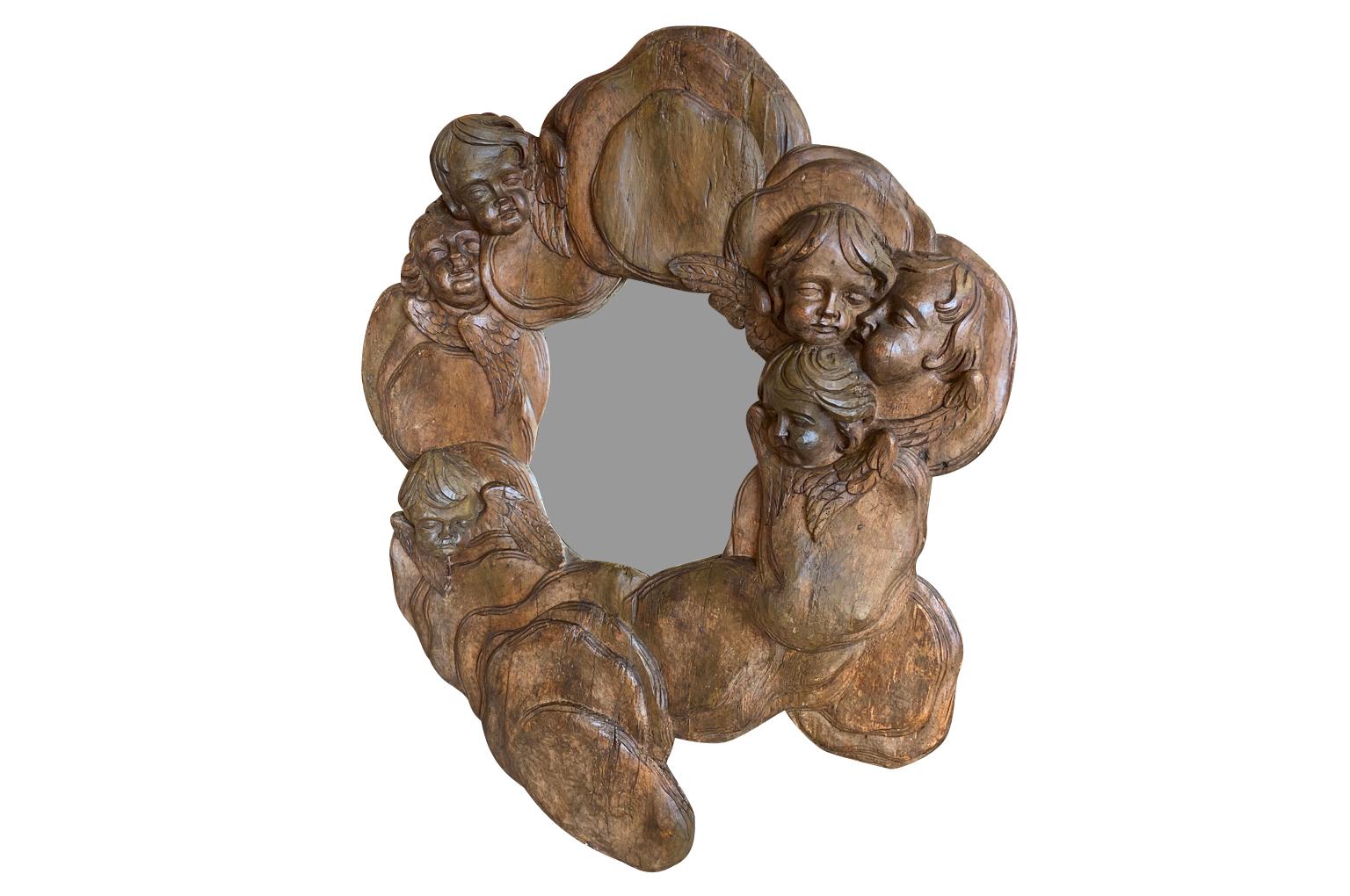 An exquisite 17th century Venetian Looking Glass - Mirror.  Masterly crafted in beautiful walnut with wonderful putti heads and clouds.  This mirror will be the star of its surroundings. 