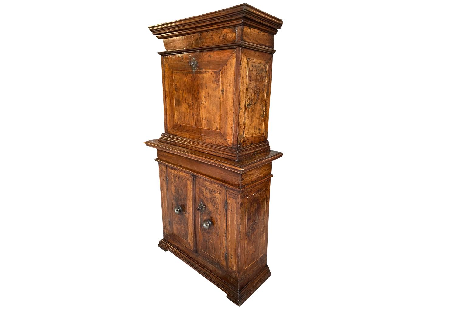 A stunning 17th century Secretaire from Bologna, Italy. Wonderfully constructed from beautiful walnut with the upper section having a fall front secretary. Once opened to expose a series of drawers with fruitwood inlay. The cornice lifts to expose a