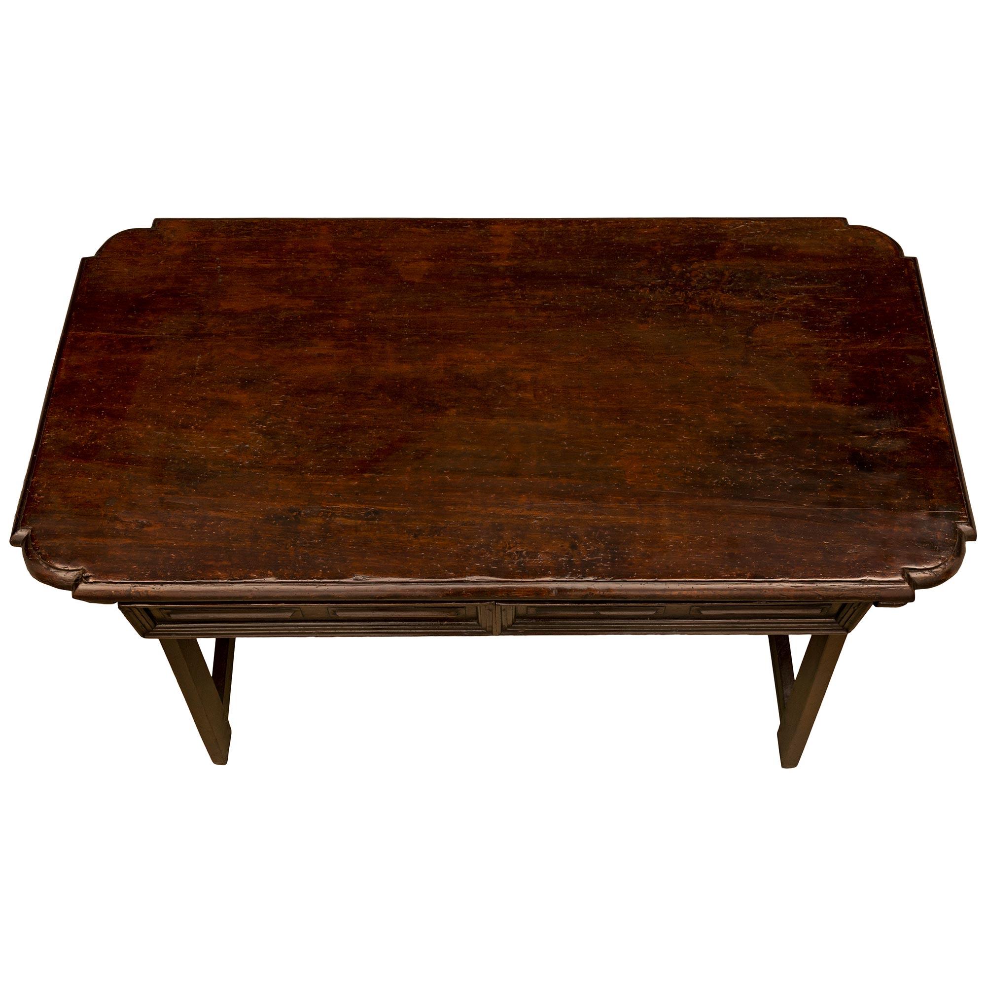 A beautiful Italian 17th century Tuscan st. Walnut desk/side table. The two drawer desk is raised by sleek rectangular tapered legs at a most decorative slanted angle connected by a straight horizontal stretcher with a beautiful X shaped support. At