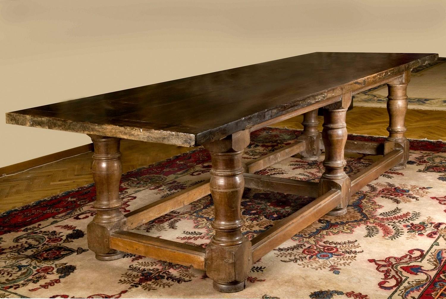 This charming 17th Century massive scale rectangular refectory table, dating back to Baroque period, is a magnificent example of Tuscan rustic craftsmanship.
The top consists of four large solid warm brow walnut planks capped on either end with