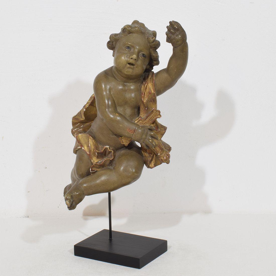 Beautiful handcarved angel in baroque style. Unique period piece made out of wood . Hand-carved 
Italy, circa 1780-1850
Weathered. Small losses.

Measurement here below includes the wooden base.
H:36,5cm  W:20cm D:14cm 