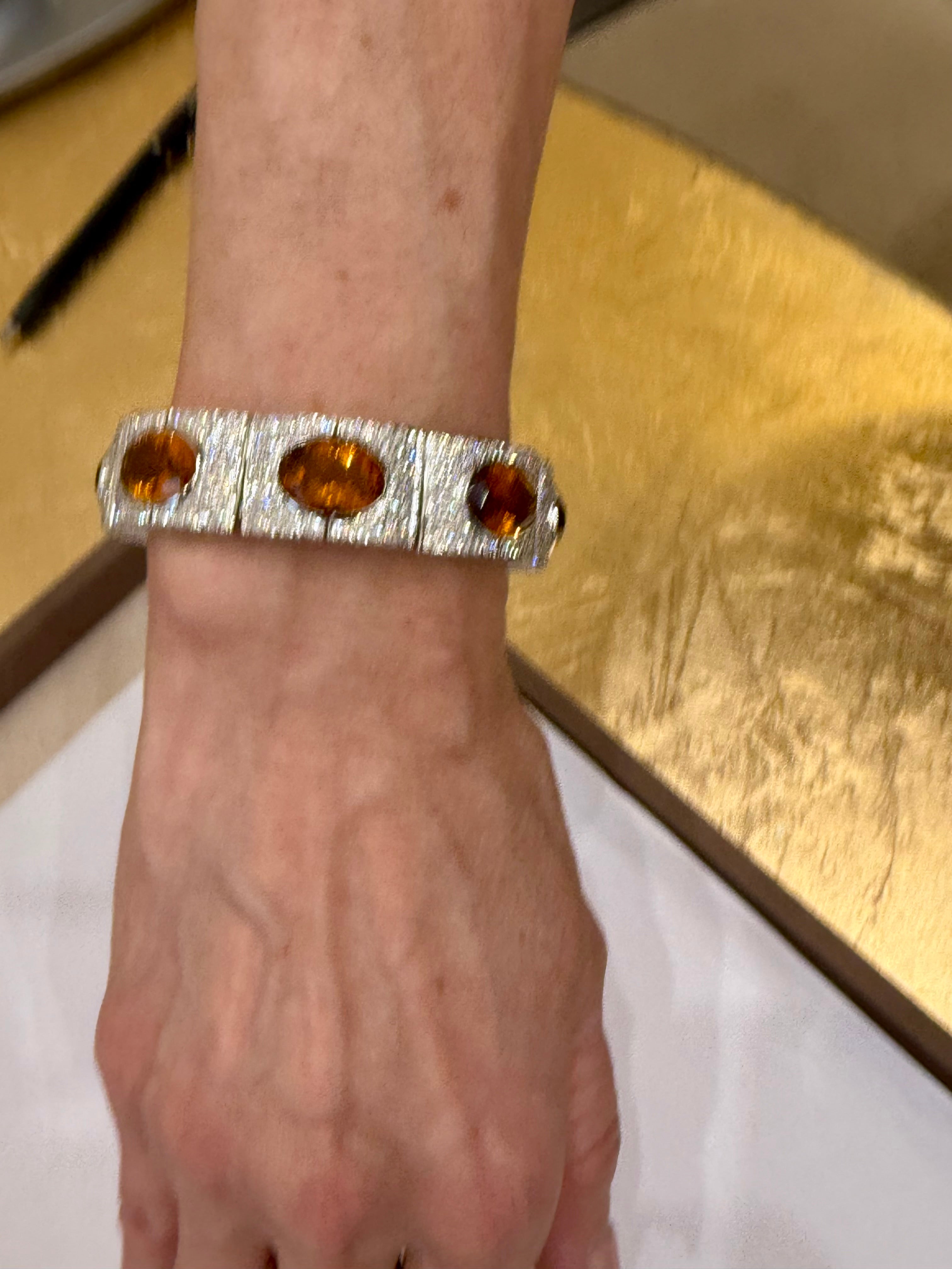 An extremely attractive bracelet in 18 K white Gold that captivates wtih the fascinating color of the 8 oval bezel set Madeira Citrines. Total weight of the Citrines approximately 48 ct. The Bracelet is further enhances by the sparkle of 352
