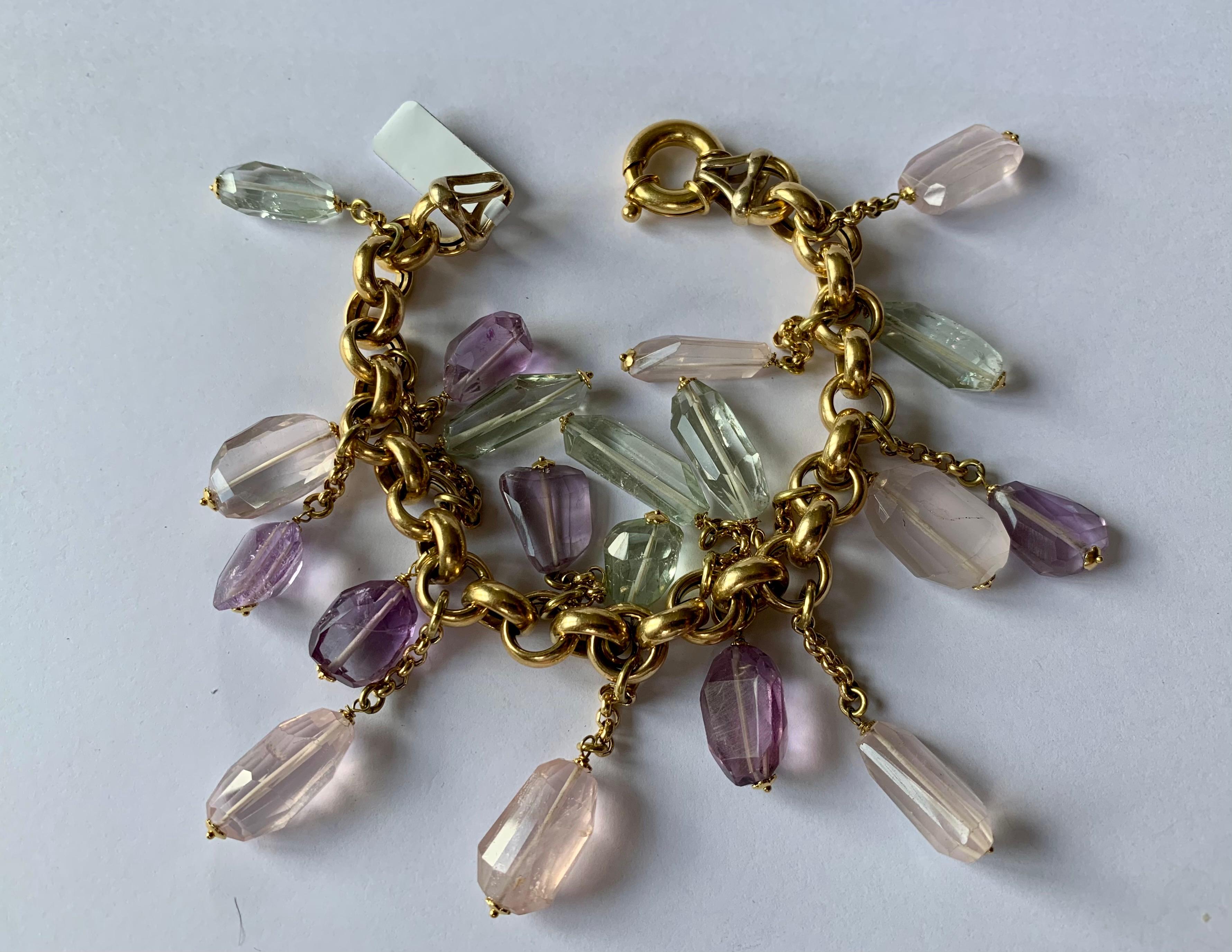 A lovely and playful 18 K yellow Gold charm bracelet with Rose Quartz and Amethysts and Prasiolite. 
A romantic design with pastel gemstones. 
Made in Italy. 
Length: 21 cm. 
Masterfully handcrafted piece! Authenticity and money back is