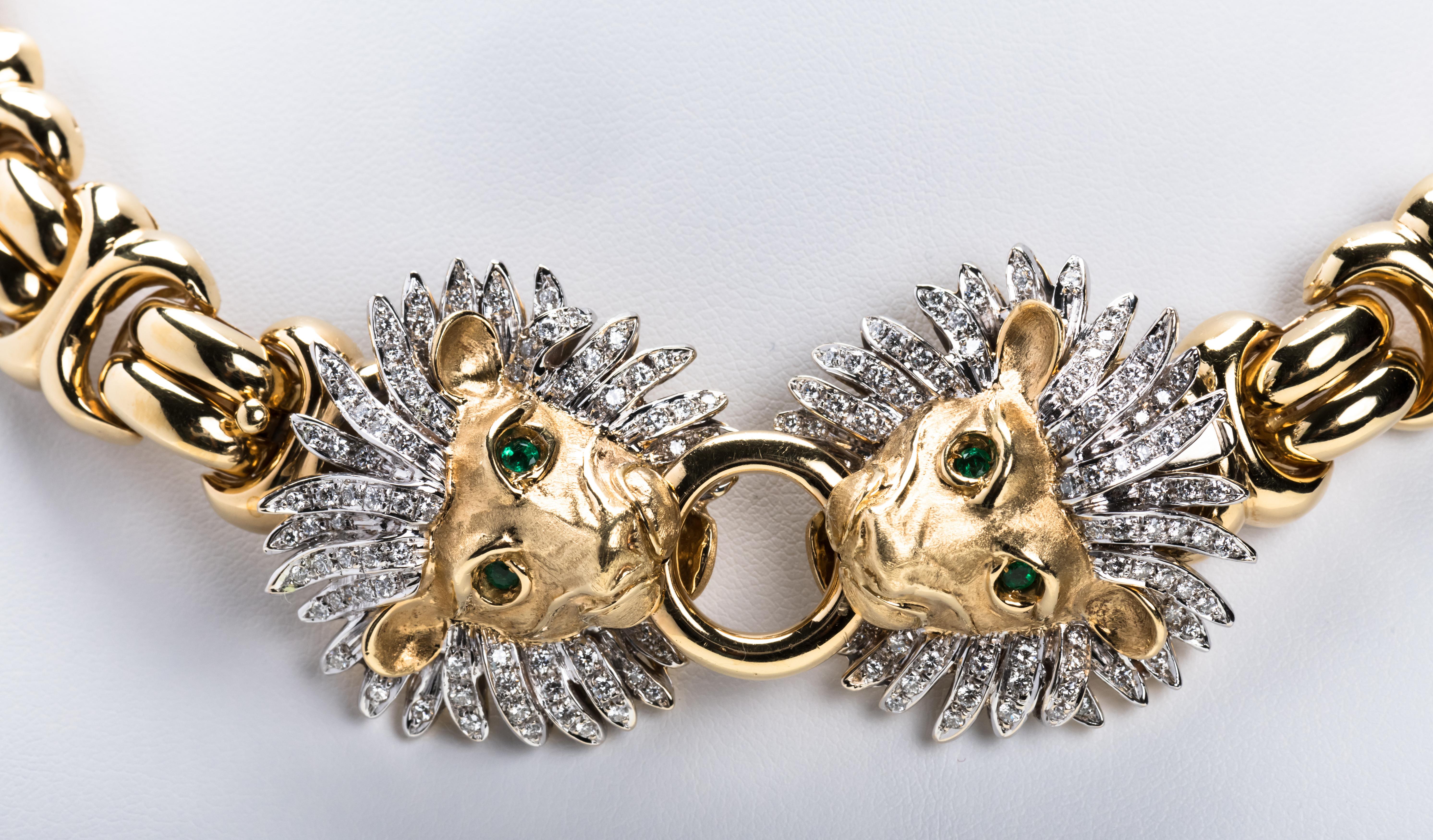 Highly stylized 18 karat gold Italian hand made collar necklace with interconnecting links. The bottom of the necklace has two large lion heads with inset diamonds in the manes and inset emerald eyes. The quality and craftsmanship is