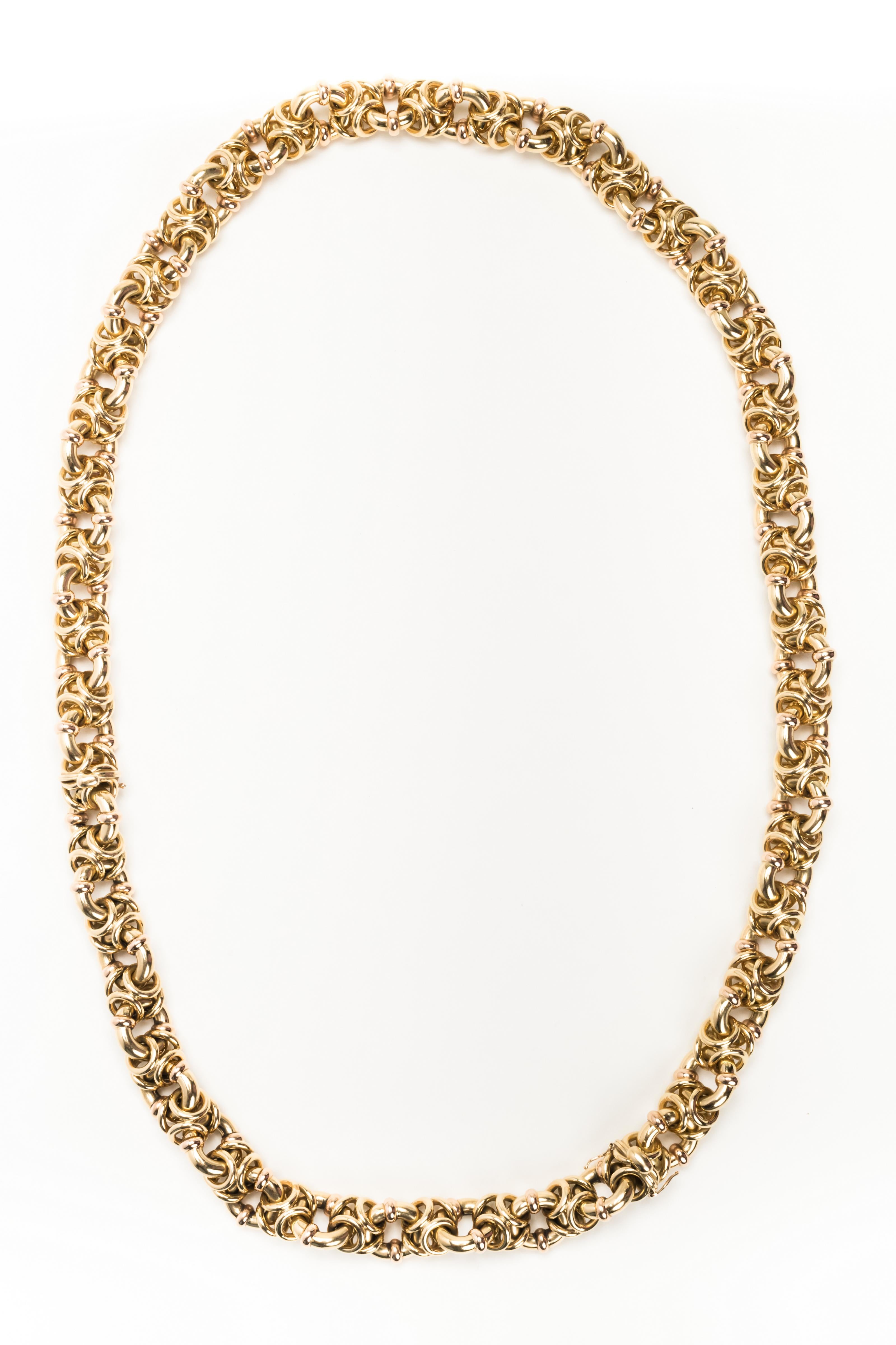 Intricate Italian multi-looped 18 karat gold necklace with detachable bracelet. Stamped 750.

Size: Total length: Necklace: 28