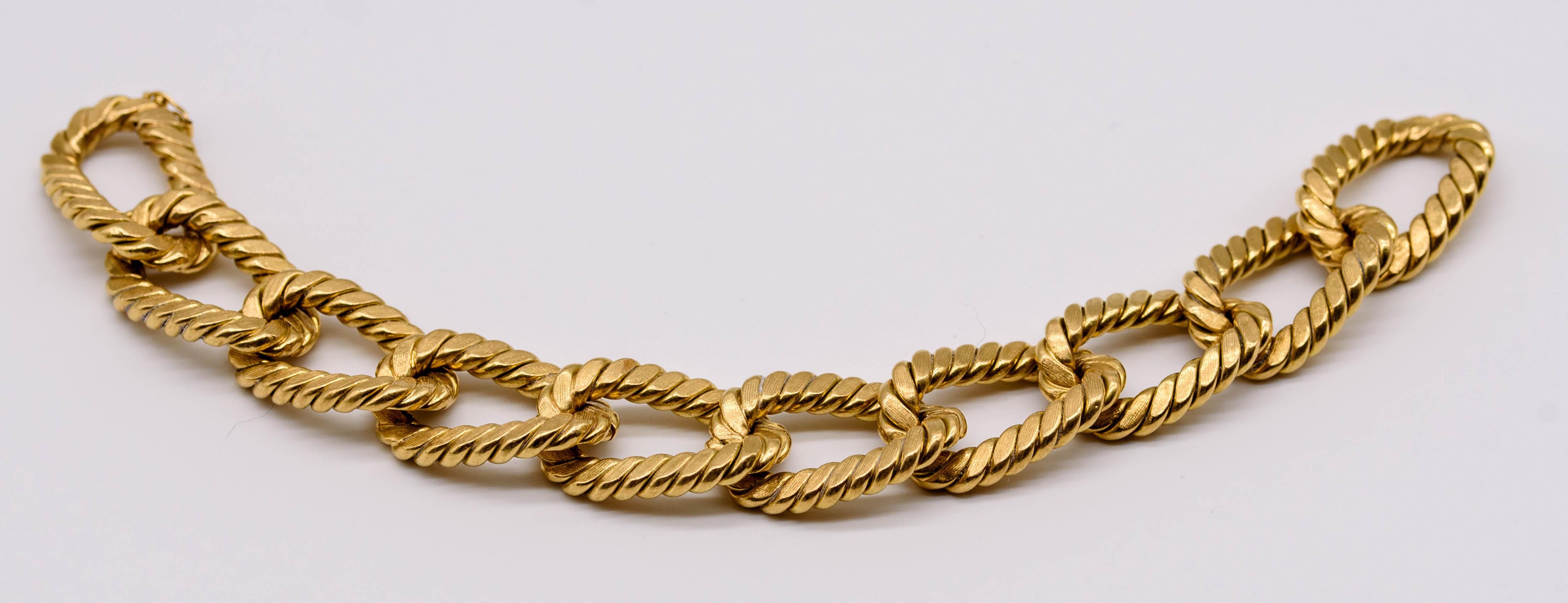 An elegant and wearable gold bracelet that transcends time.   Elongated oval links are formed from flattened and engraved ropes of gold emulating the thick ropes that secure ships to the shore.  One side of the bracelet is florentine finish (a soft,