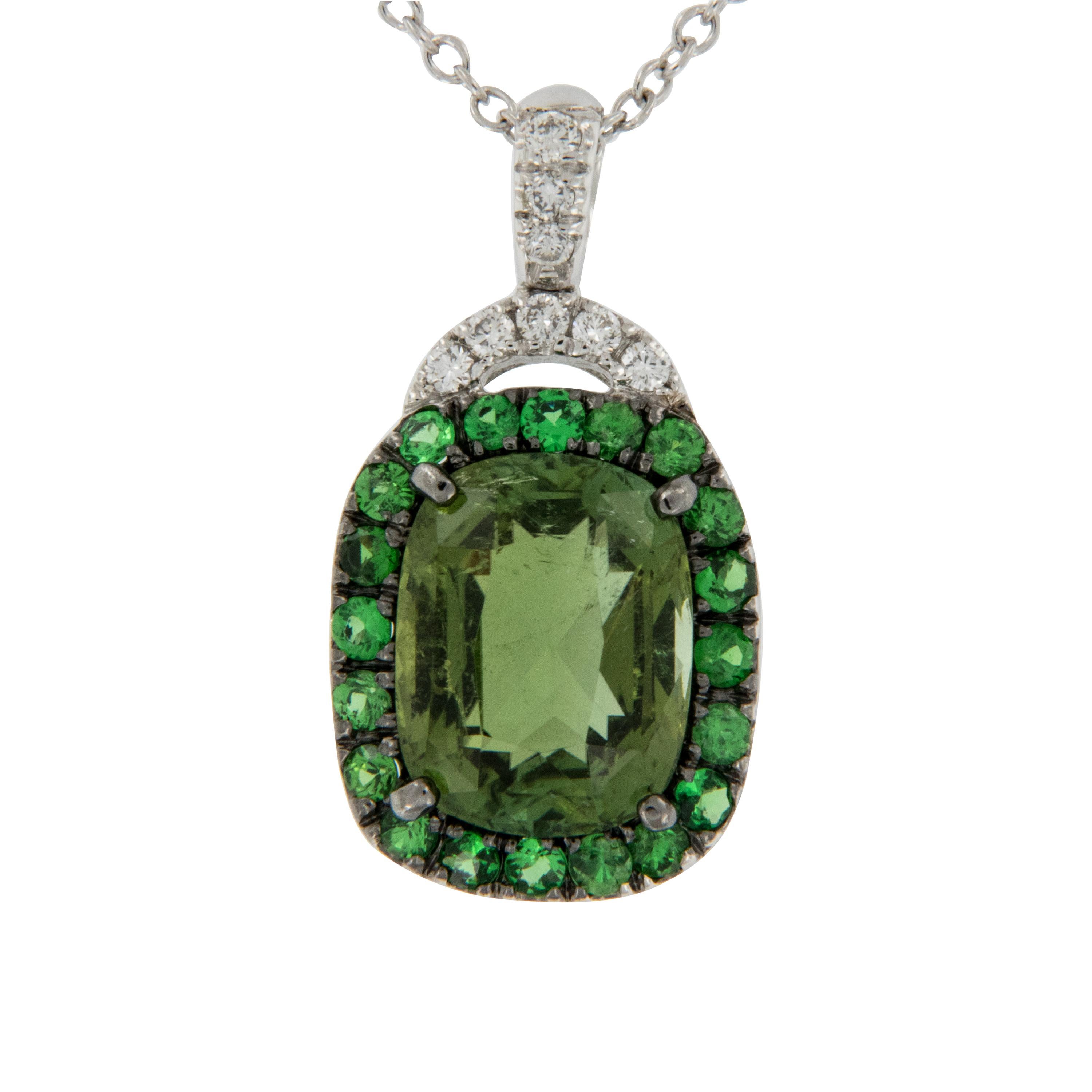 Made in Italy & as soothing as lush green leaves, this eye catching necklace features a 4.08 carat cushion cut 
Green Tourmaline hugged by bright green Tsavorite garnets in the halo for a stunning tone on tone effect! Accented with white diamonds on