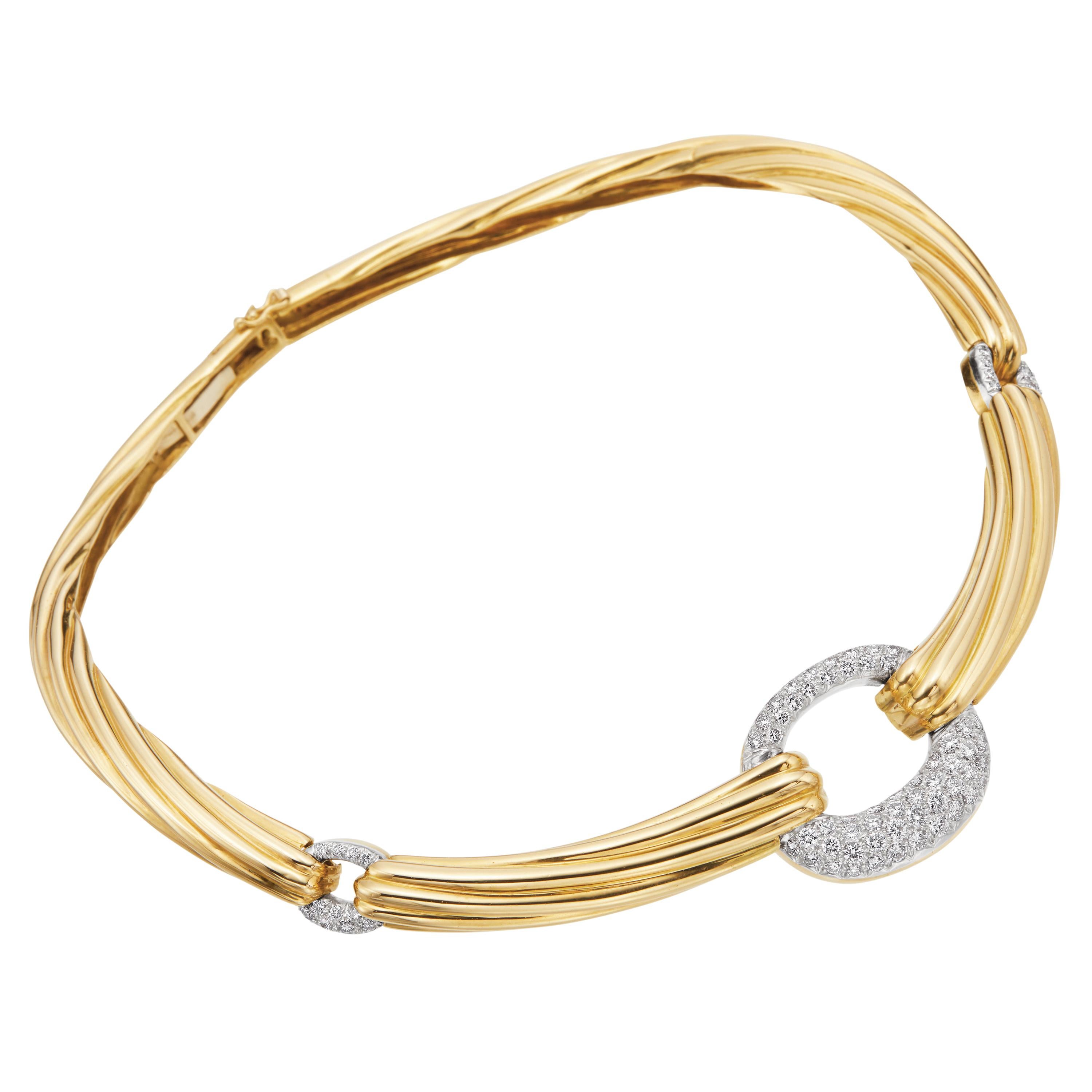 Straight from Italy's finest craftsmanship, comes this elegant and breathtaking collar necklace. This 18K Italian yellow gold textured necklace is prefect for evening wear with its three open circle 3.00ctw diamond paves that sit perfectly on the