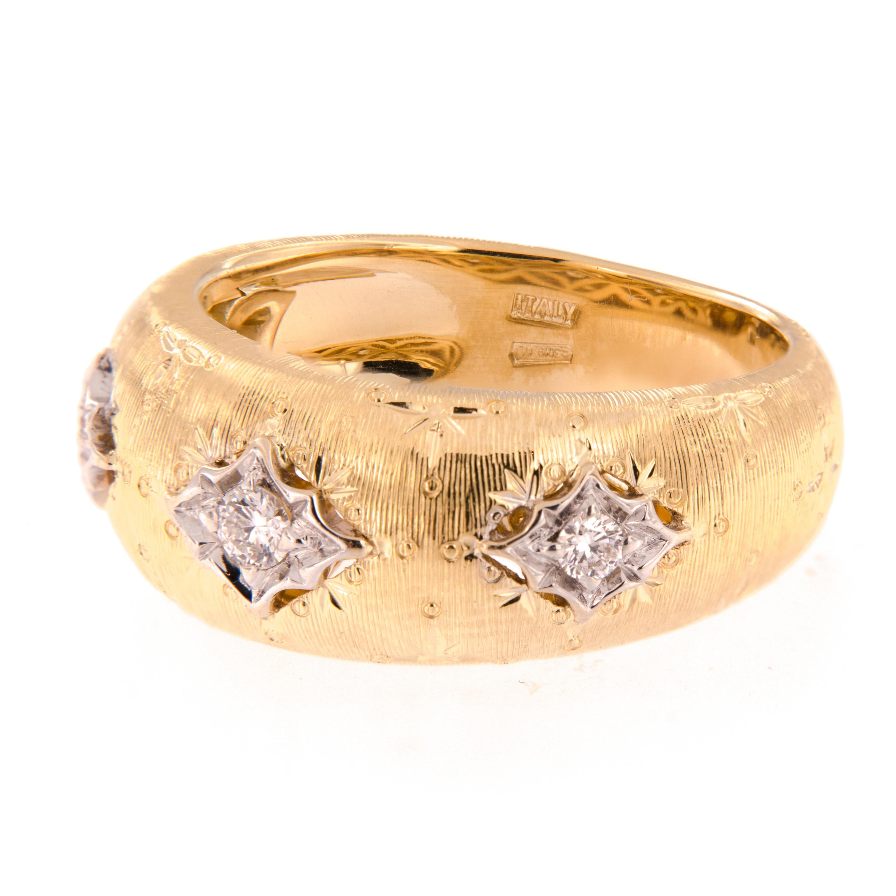 Expert Italian craftsmanship in 18k yellow and white gold band ring accented with diamonds. Ring is inspired by the classic design featuring textured gold made to look like fine fabric. Ring is a size 6 but can be modified. Complimentary signature