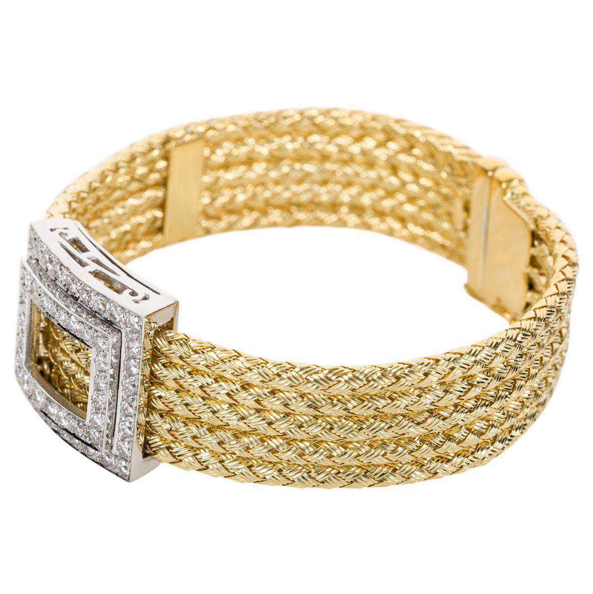 A finely made 18k yellow gold Italian multi-strand (5) plaited bracelet with an 18k white gold rectangular shaped centre piece containing 52 grain set diamonds. The diamonds weigh approximately 1.30cts in total and are G colour, VS clarity - modern