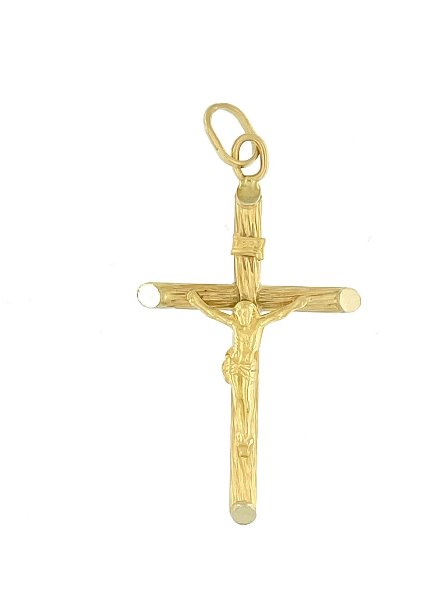 The Italian 18 karat Yellow Gold Classic Crucifix is a timeless and elegant religious pendant crafted with meticulous attention to detail. The crucifix features intricate relief work, showcasing a skillful blend of artistry and craftsmanship. The