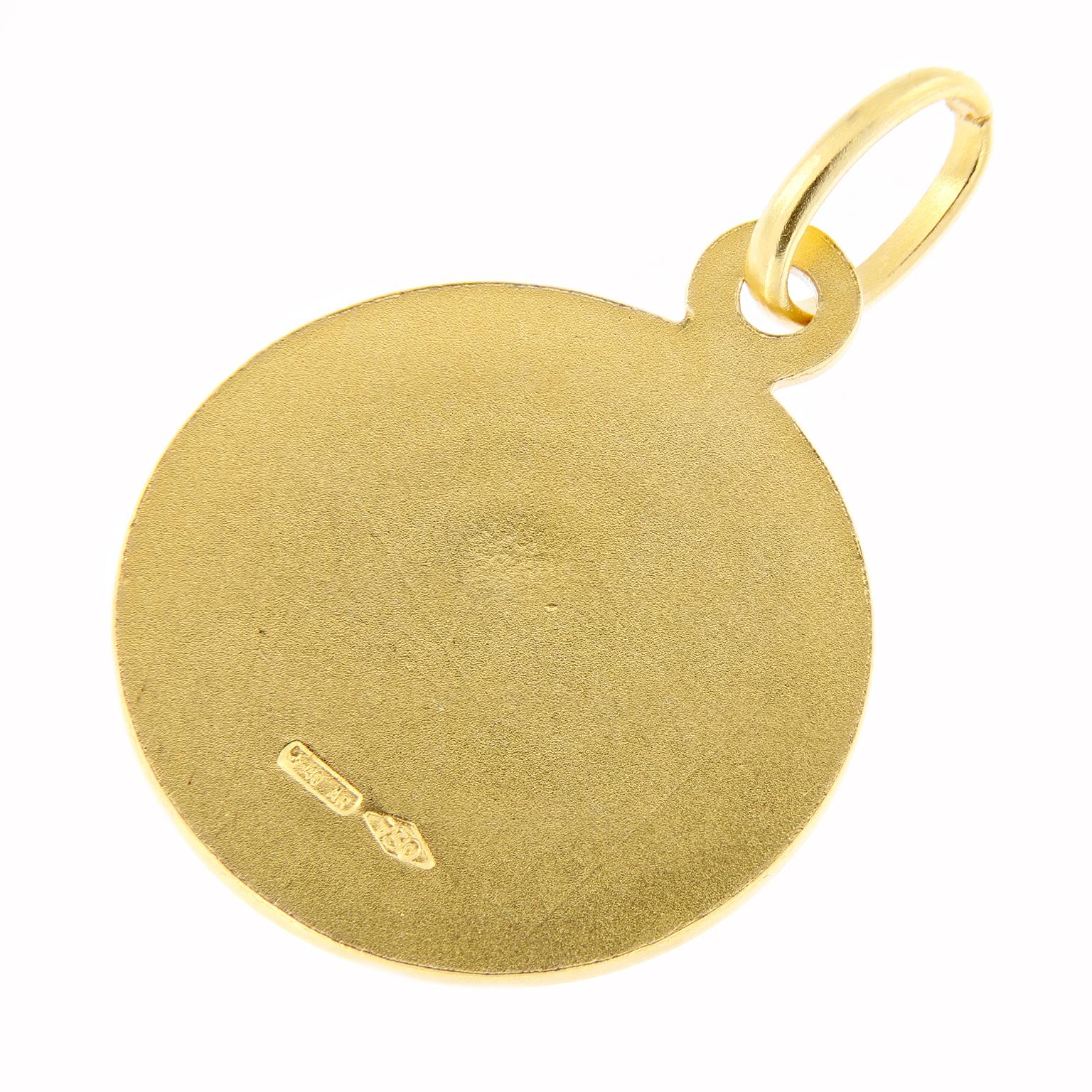 This round brand new, never worn old stock Jesus medal is made of polished and textured royal 18 karat yellow gold with high relief. Can be worn on a chain as a necklace or as a charm on a bracelet. Diameter: 12mm. 
18KYG
12mm diameter