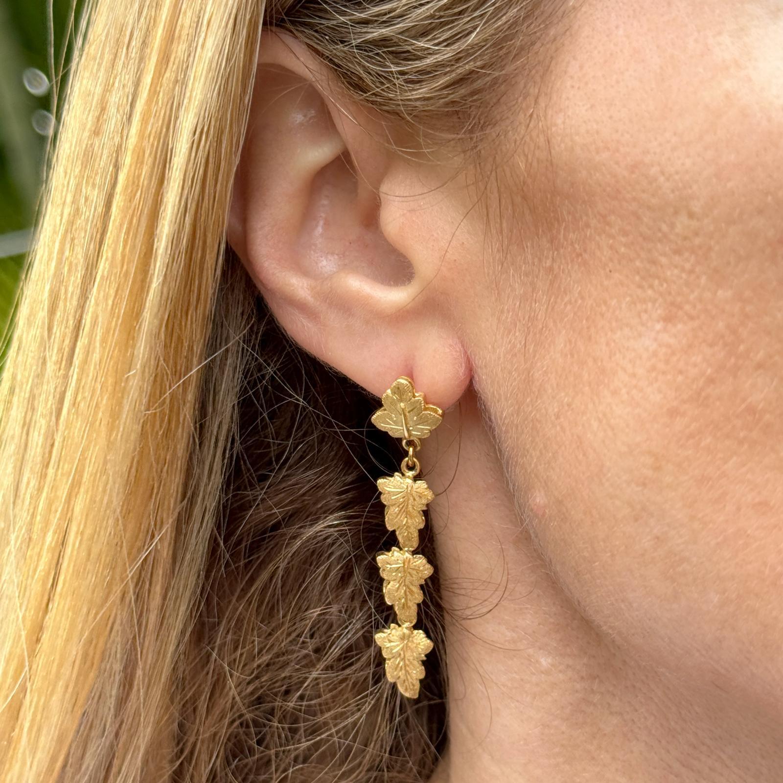 Italian designer leaf motif dangle earrings handcrafted in satin finish 18 karat yellow gold. The earrings measure 1.90 inches in length. Weight: 8.7 grams. Signed Fabbrini. Weight: 8.7 grams.