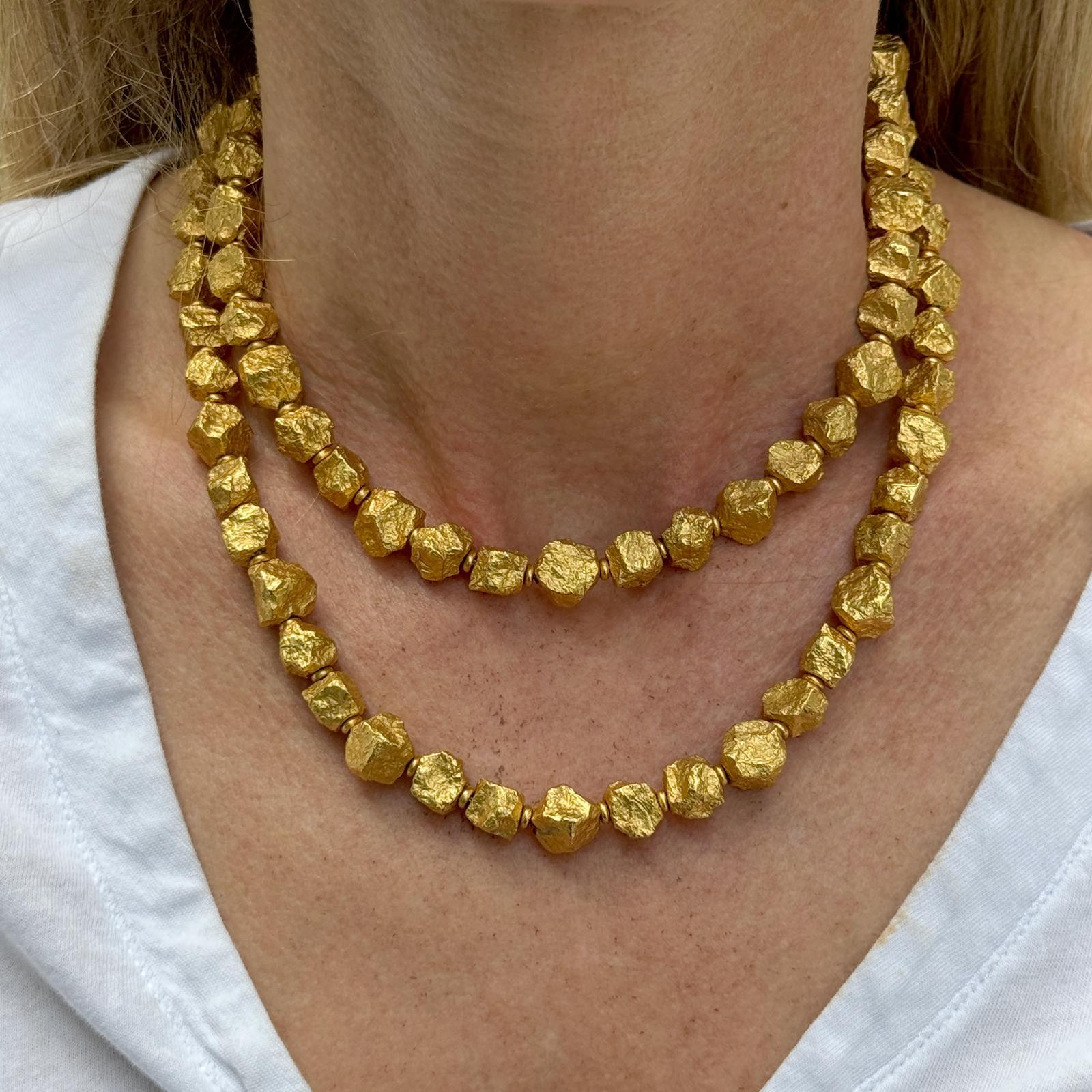 The Italian Nugget Link Necklace is a luxurious and striking piece, measuring 31.5 inches in length. Crafted from rich 18 karat yellow gold, this necklace features an intricate nugget link design that exudes elegance and sophistication. The push