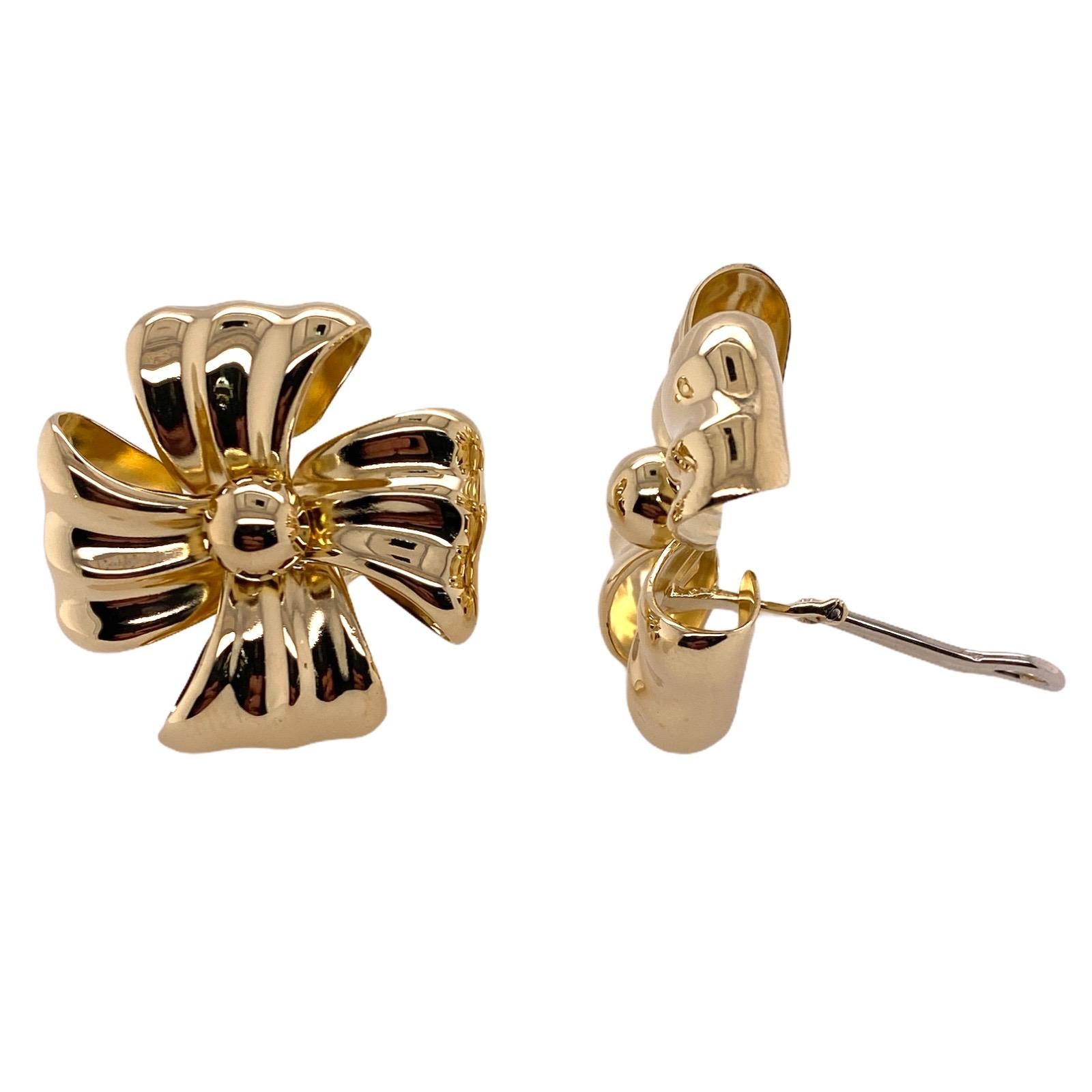 Italian ribbon earrings fashioned in 18 karat yellow gold. The earrings, circa 1970's,  measure 1.25 x 1.25 inches and feature clip backs (post can be added). 