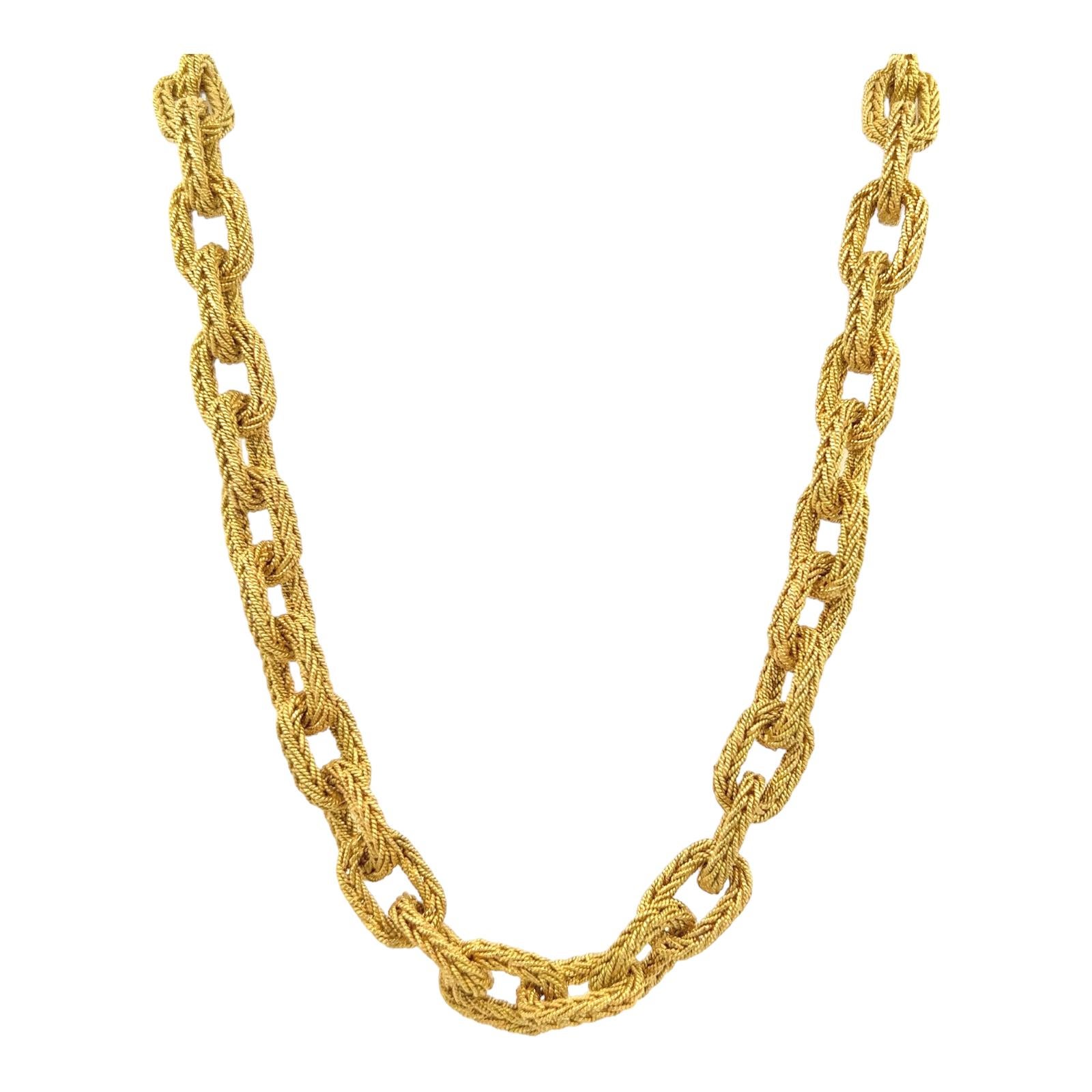 Beautifully crafted Italian link necklace crafted in 18 karat yellow gold. The textured oval link necklace measures 17 inches in length with a hidden clasp and safey. Stamped Italy 18K. 