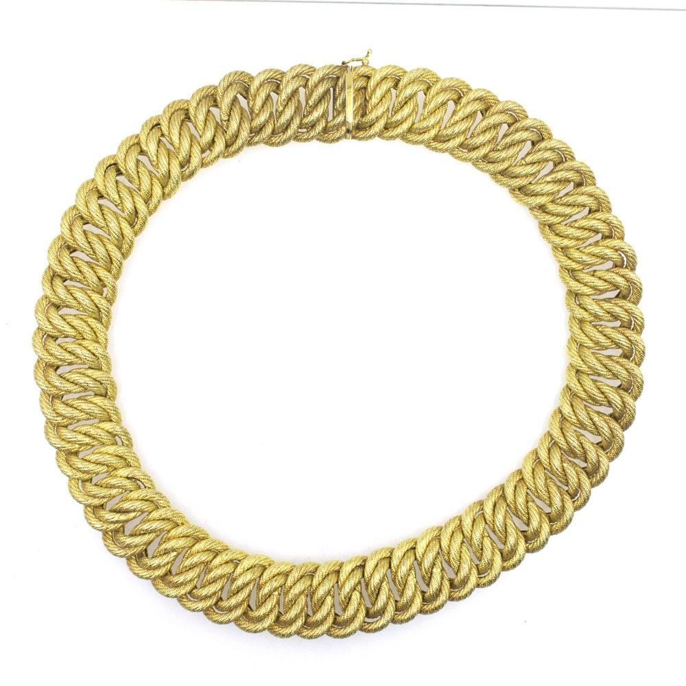 This beautiful and timeless Italian link chain is fashioned in 18 karat yellow gold. The textured links measure .75 inches in width and 17 inches in length. Stamped Italy 750 and hallmarked. 