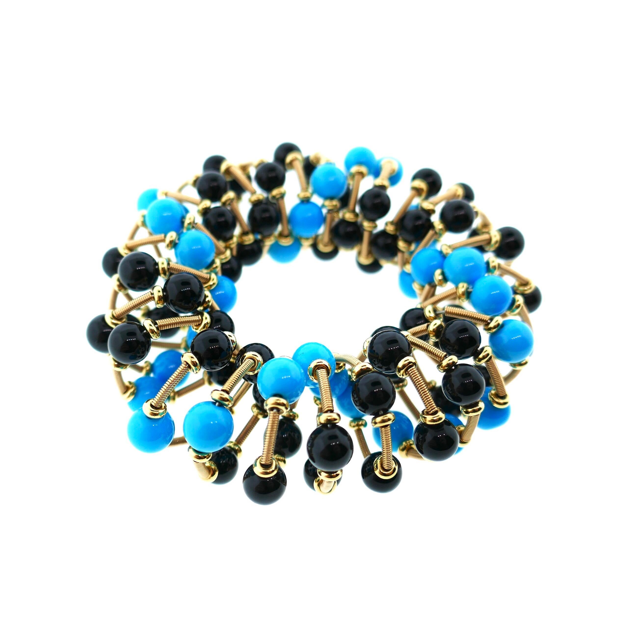 Italian 18 Karat Yellow Gold Turquoise and Onyx Scrunchie Bracelet

This is a one of a kind Italian bracelet. The design incorporates springs so it stretches like a scrunchie and  can accommodate any size wrist. The workmanship is amazing as is the
