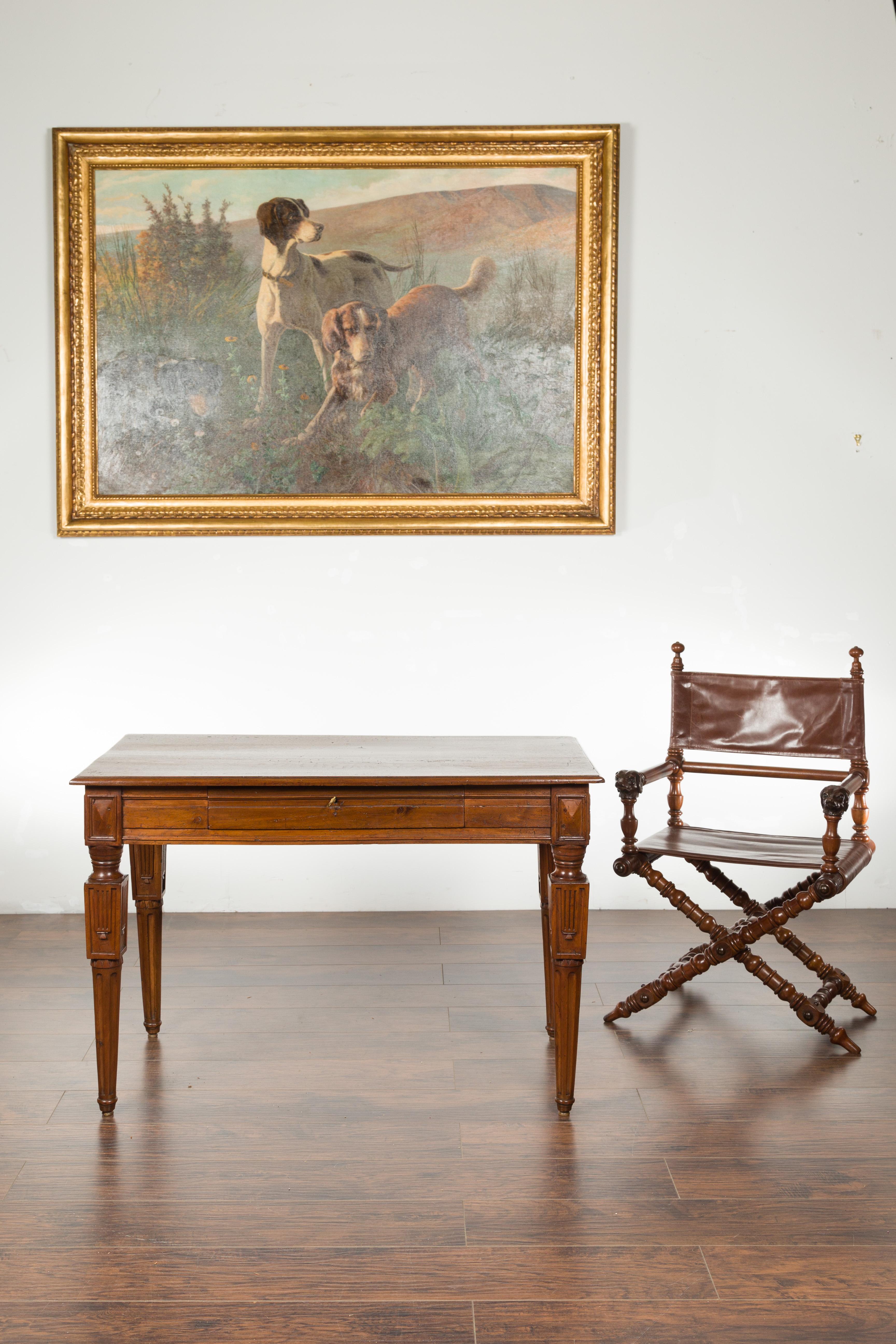 An Italian walnut side table from the early 19th century, with carved fluted legs and single drawer. Created in Italy during the early years of the 19th century, this walnut side table features a rectangular planked top with single drawer in the