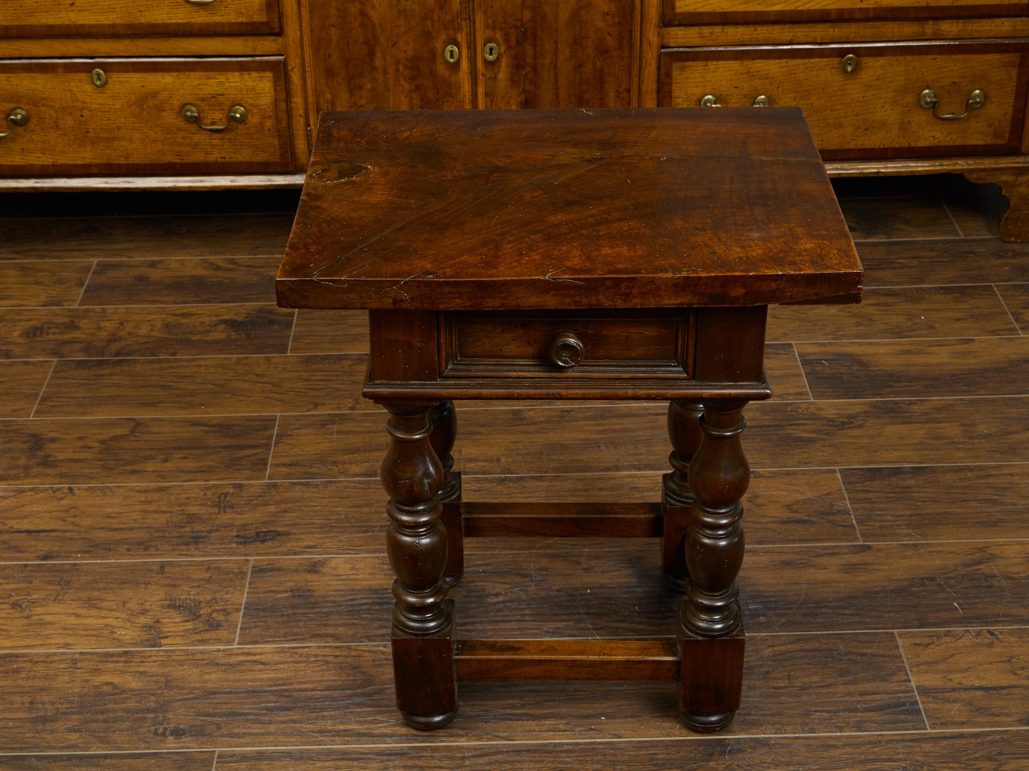 An Italian walnut side table from the early 19th century, with single drawer and turned legs. Created in Italy during the early years of the 19th century, this walnut side table features a rectangular top sitting above a single drawer fitted with a