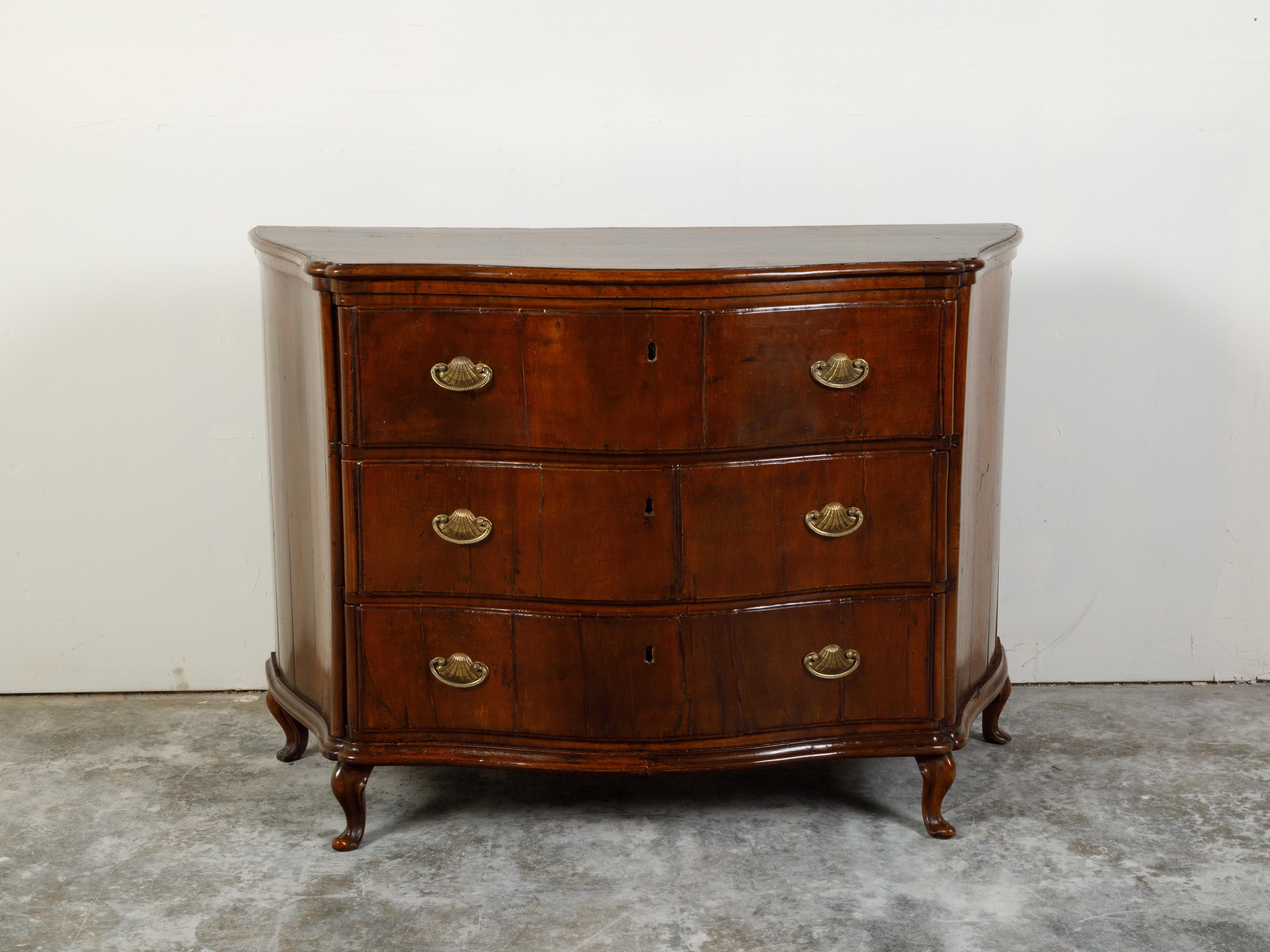 An Italian walnut commode from the early 19th century, with three drawers, serpentine front and bronze hardware. Created in Italy during the early years of the 19th century, this walnut commode features a rectangular top with serpentine front,