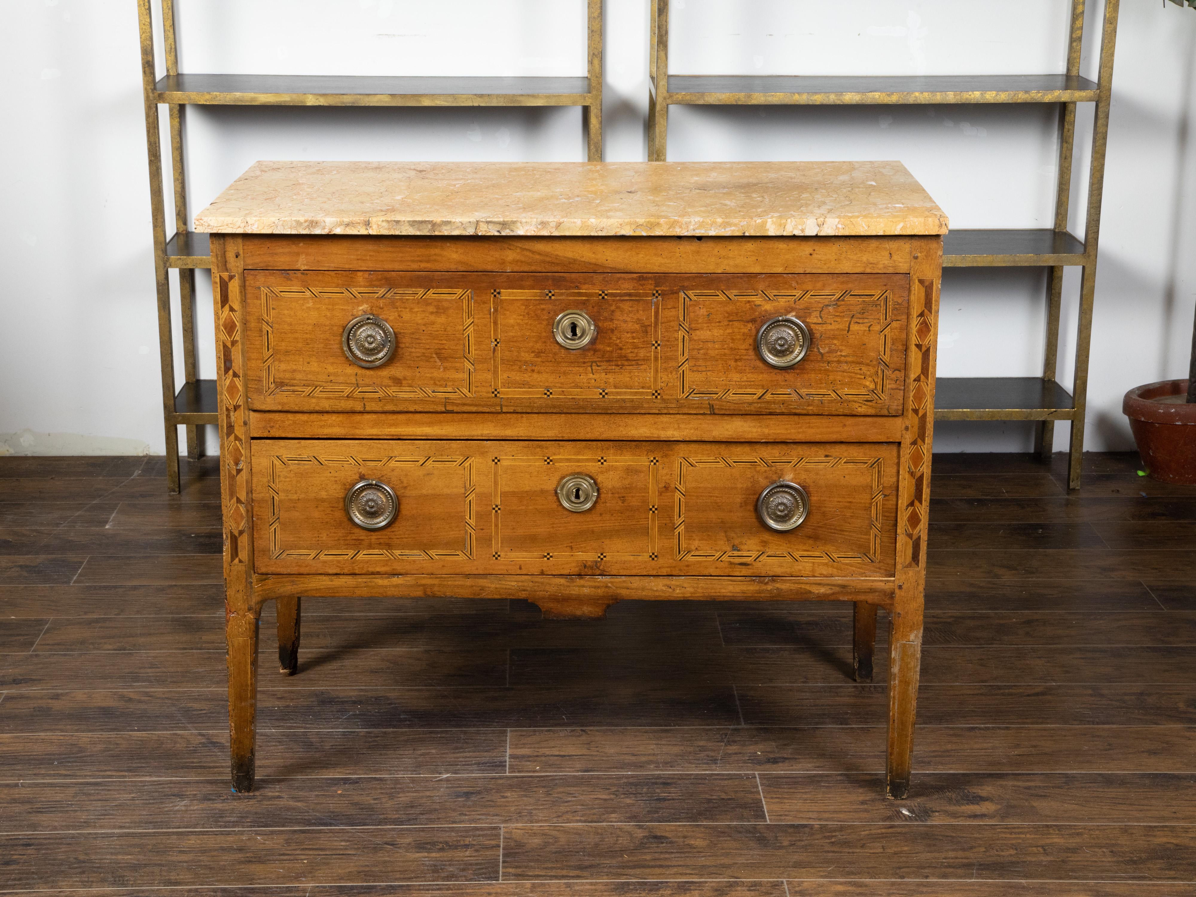 An Italian walnut commode from the early 19th century, with yellow marble top, two drawers and inlay. Created in Italy during the early years of the 19th century, this walnut commode features a rectangular yellow marble top sitting above two drawers