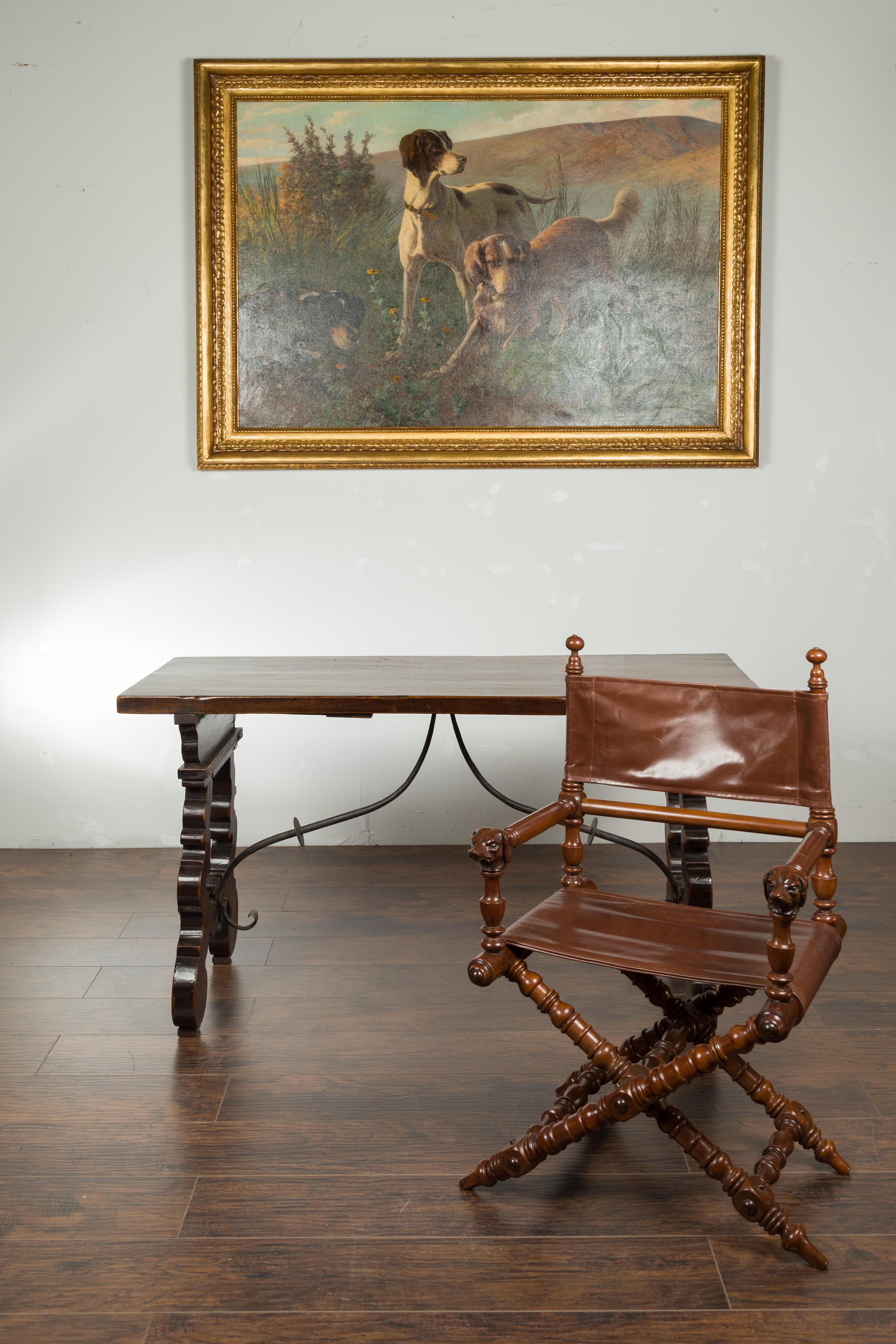 An Italian walnut Fratino table from the early 19th century, with iron stretcher and extension leaves. Created in Italy during the first quarter of the 19th century, this Fratino table features a rectangular top sitting above a lyre shaped base,
