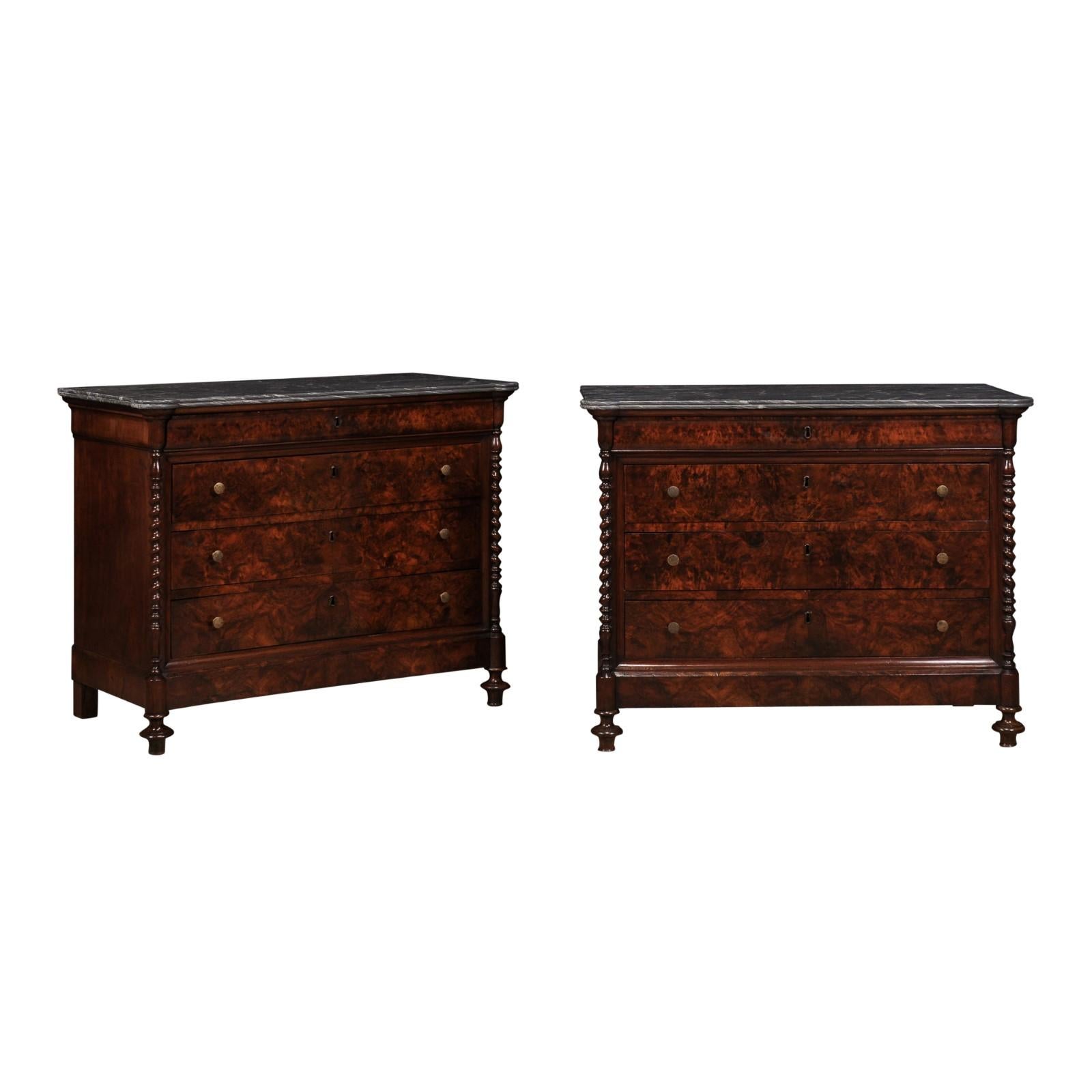 A pair of Italian 1830s burl walnut commodes from Lombardi with gray marble top, four drawers each, twisted columns and turned feet. Step back in time and embrace the enduring elegance of this pair of Italian 1830s burl walnut commodes from