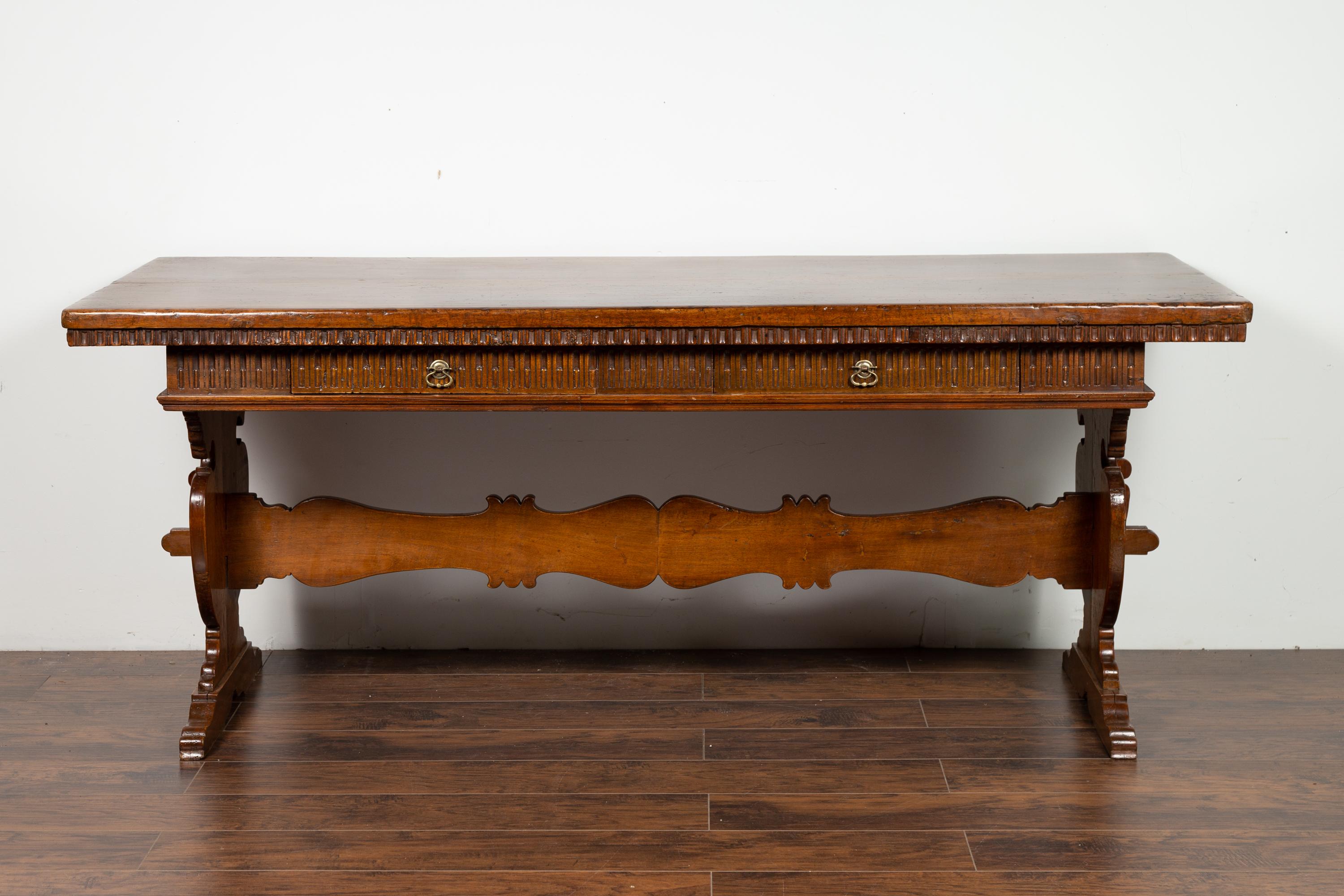 Carved Italian 1840s Walnut Trestle Table with Two Drawers and Fluted Accents