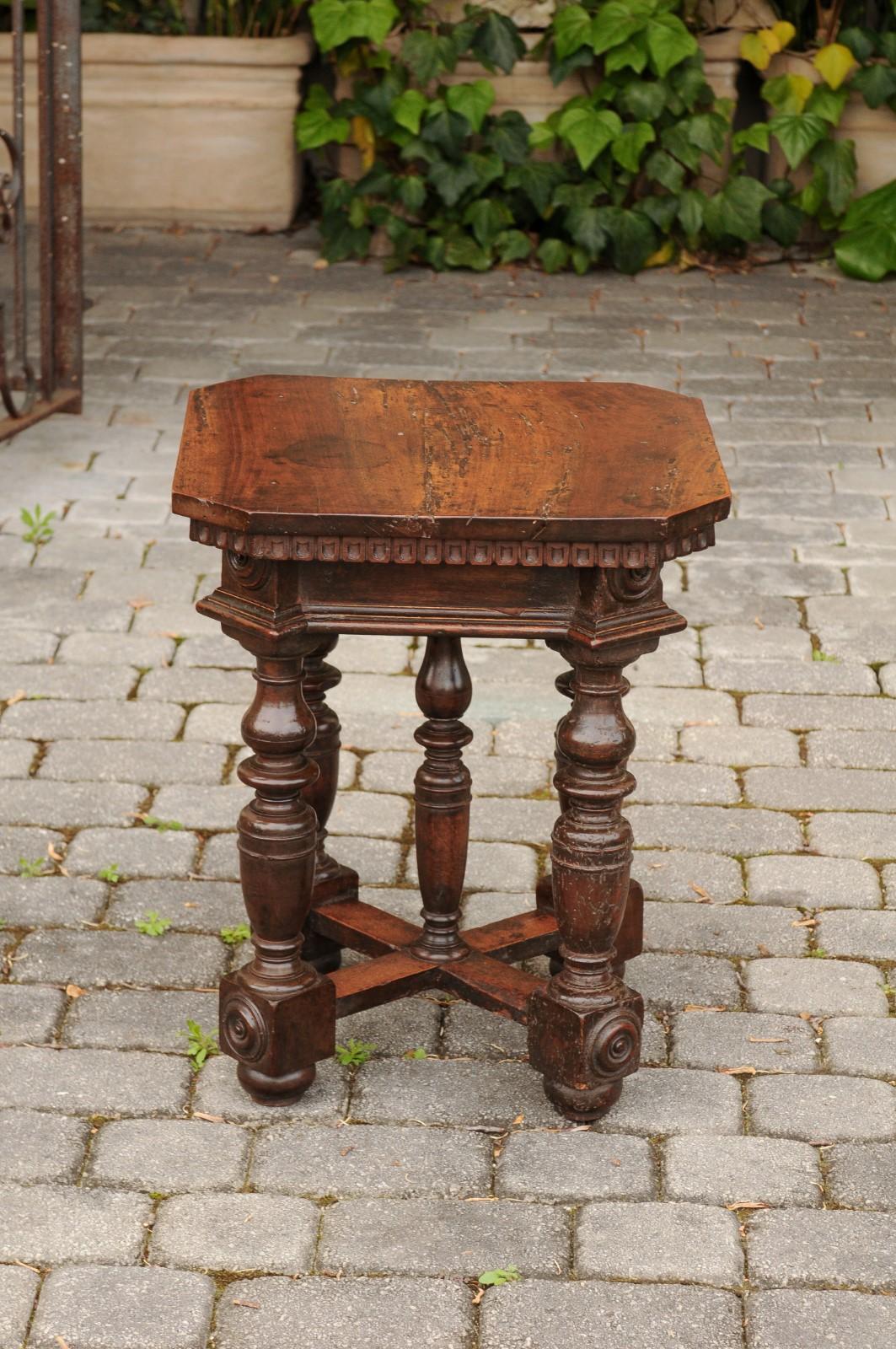 An Italian walnut side table from the mid-19th century, with scooped patterns, unusual turned base, cross stretcher and medallions. Born in Italy during the third quarter of the 19th century, this charming walnut side table features a square top
