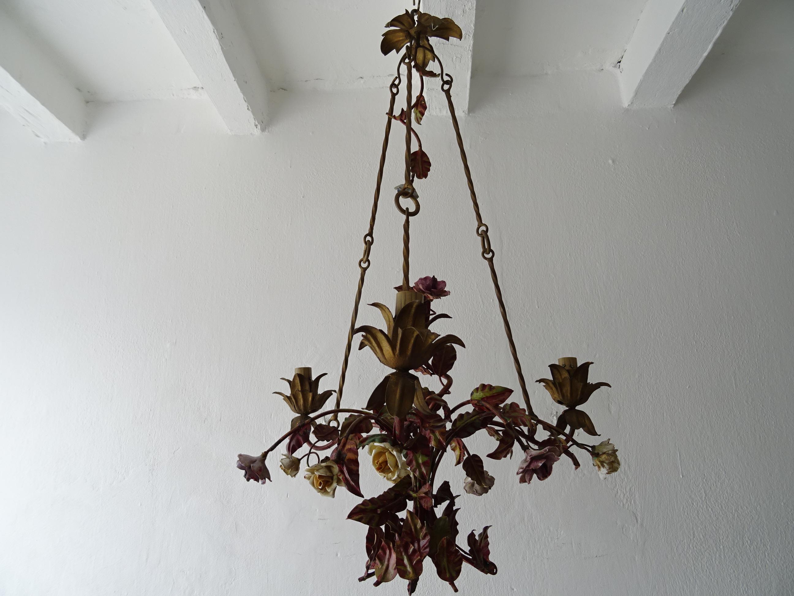 Housing 3 lights. Will be rewired with certified UL US sockets for the USA and appropriate sockets for other countries and ready to hang. Original red and green tole leaves. Handmade porcelain flowers, some may have flea bites. Rare chains with a