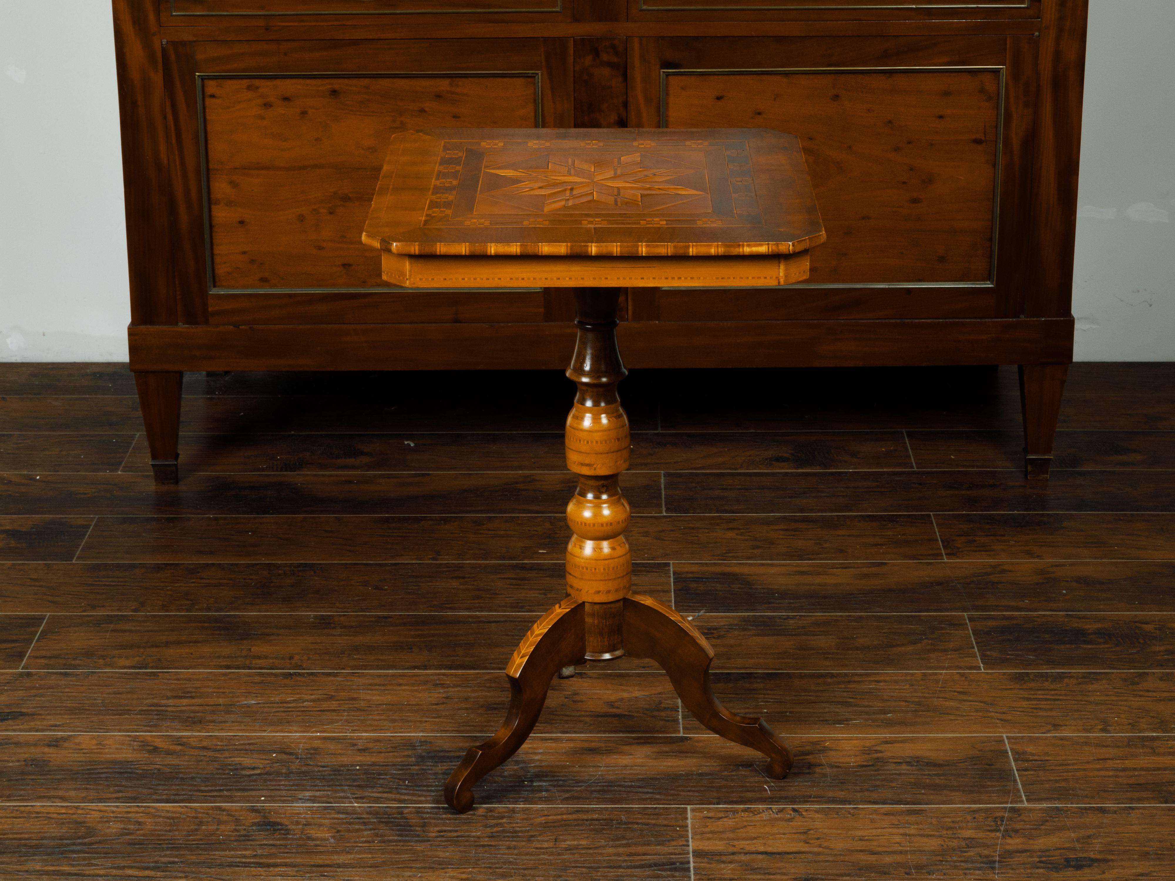 An Italian wooden guéridon from the late 19th century, with marquetry décor and tripod base. Created in Italy during the last quarter of the 19th century, this wooden guéridon attracts our attention with its lovely square top with canted corners,