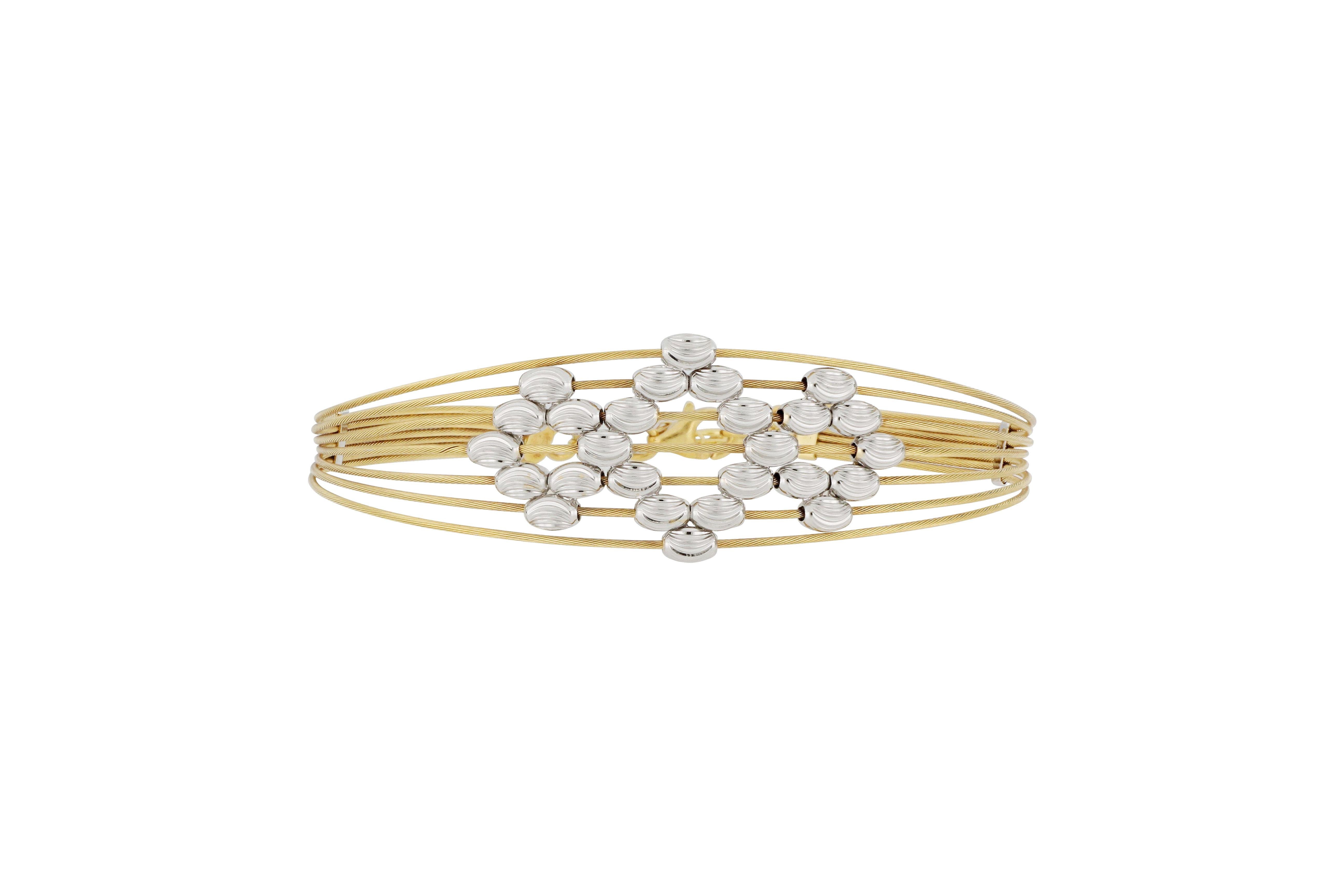 This beautiful piece of 18K yellow gold jewellery, designed and made in Italy, is composed of white gold cut beads stitched into a sparkling bangle, it is causal and  very stylish, suitable for everyday wear.
The company was founded one and a half
