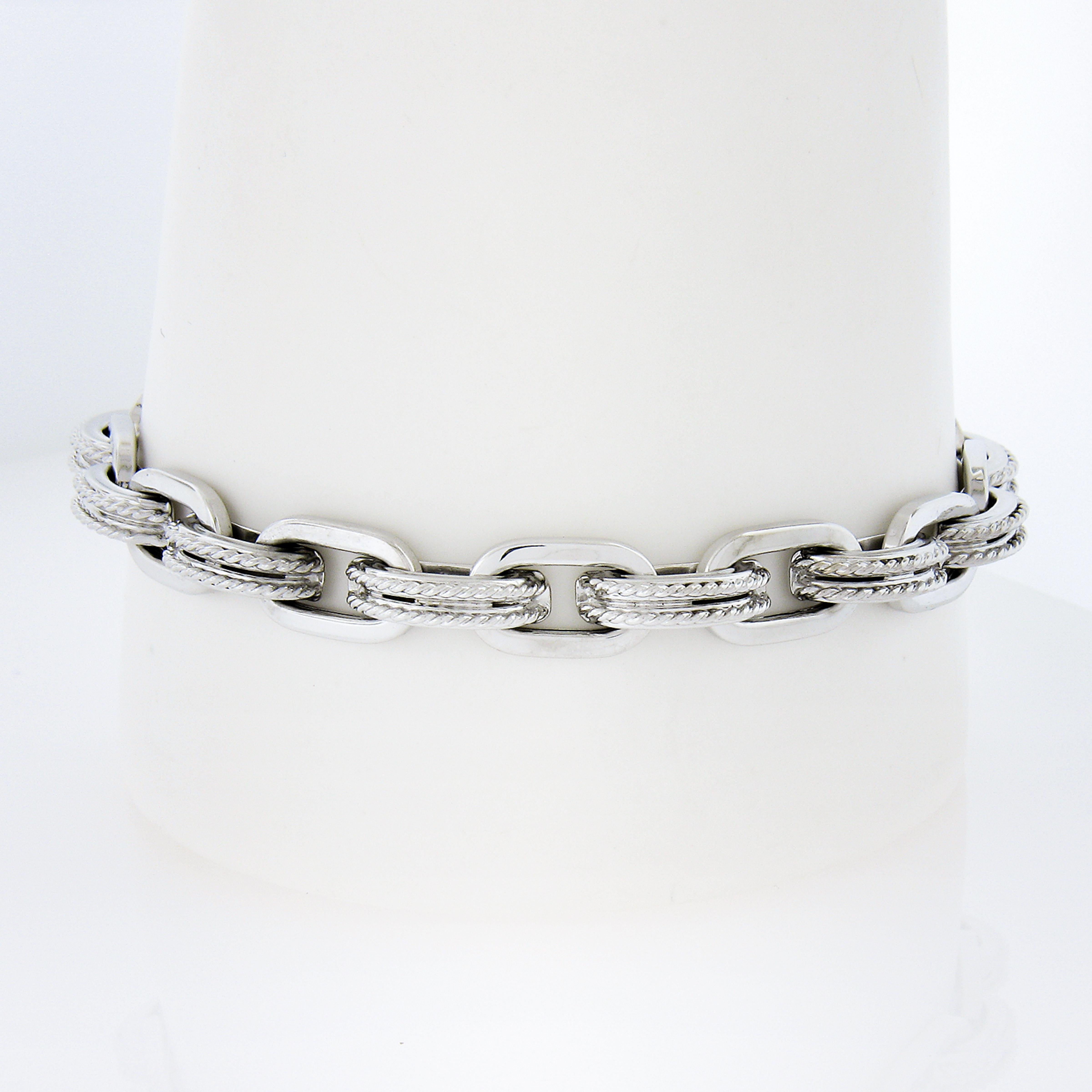 Material: Solid 18K White Gold
Weight: 17.59 Grams
Chain Type: Alternated Polished & Twisted Wire Oval Link
Chain Length: Will comfortably fit up to a 7.25 Inch wrist (Measured next to a ruler & Fitted on a wrist)
Clasp: Large Spring Ring