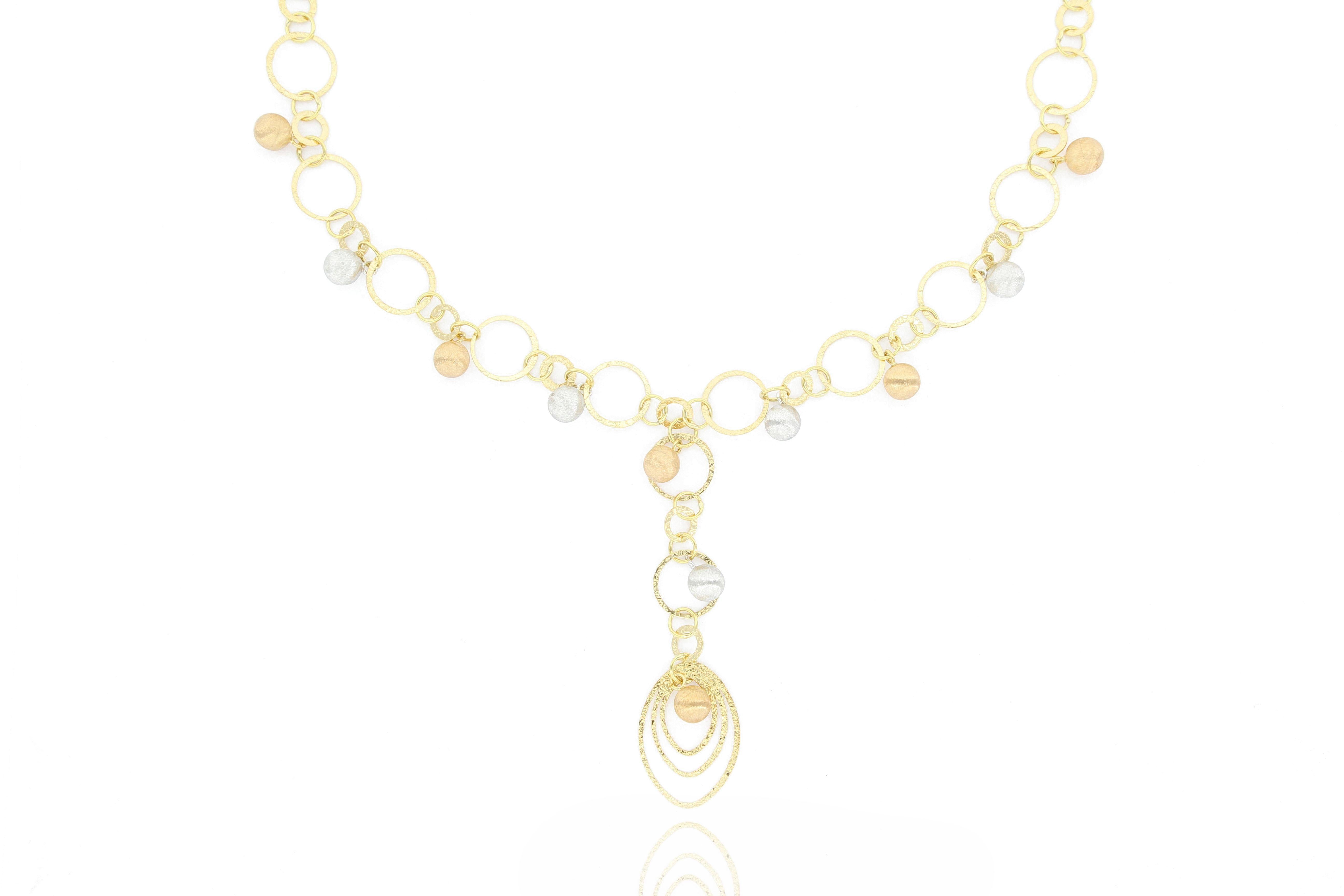 This fabulous 18K gold necklace is designed and made in Italy, unique and stylish. The jewellery piece is decorated with brushed white gold and rose gold dangling balls, perfect accessory for  stylish and casual outfits.
The company was founded one