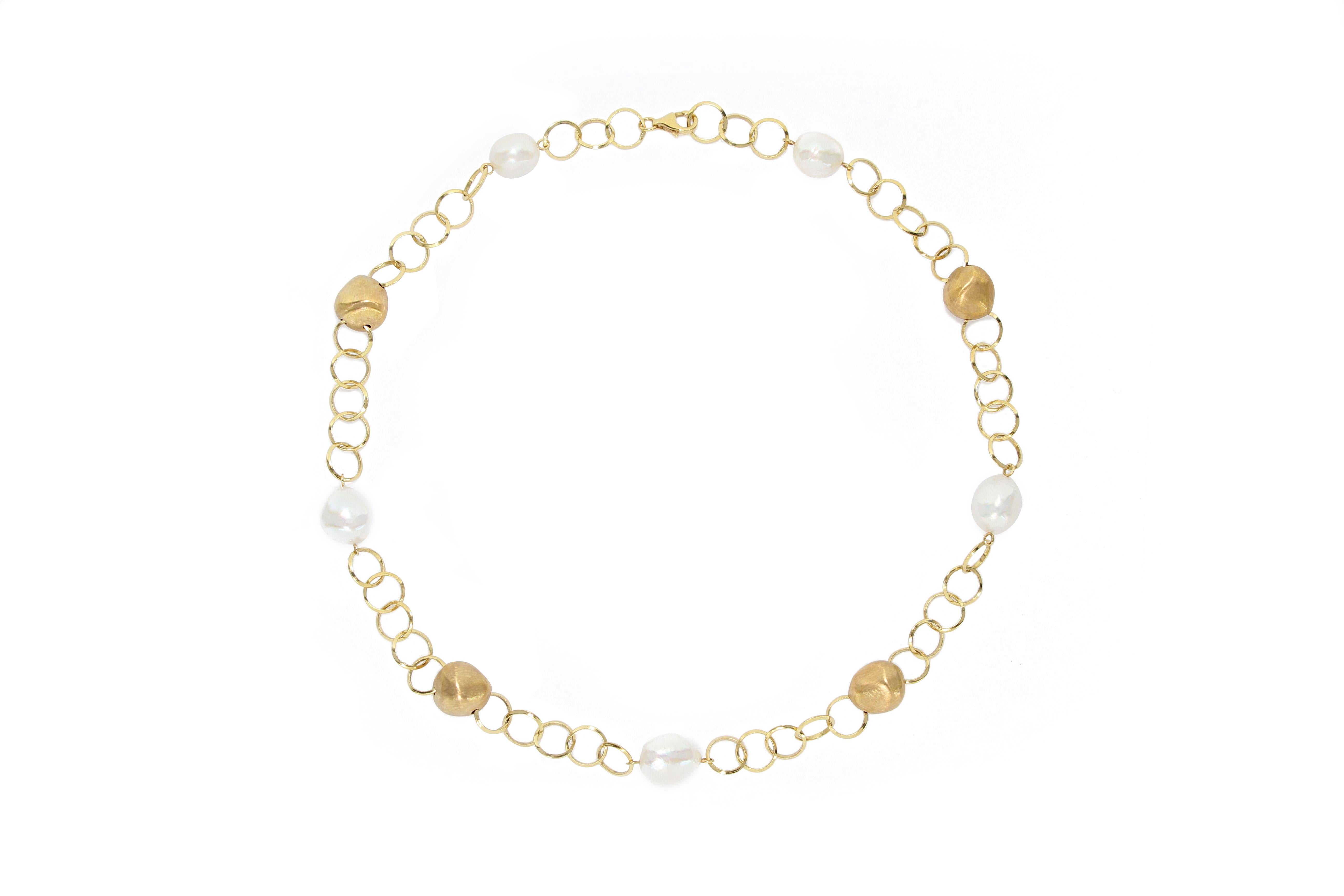 A stylish chain necklace made of 18 karat  gold  with brushed finish, decorated with 5 irregular shape freshwater pearls, designed and crafted in Italy, perfect match with jeans and casual wear.
The company is renowned for its high jewellery