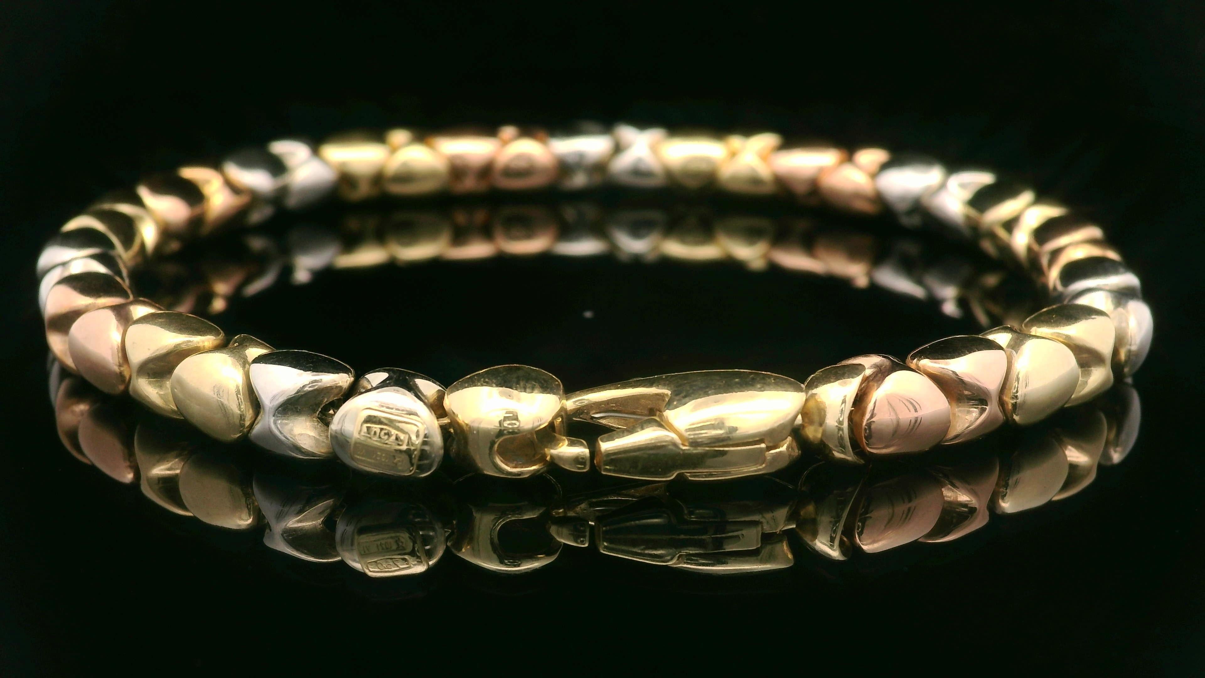 Material: Solid 18k Yellow, Rose & White Gold
Weight: 20.7 Grams
Chain Type: Sliding Beads on a Box Link Chain
Size: Measures 8