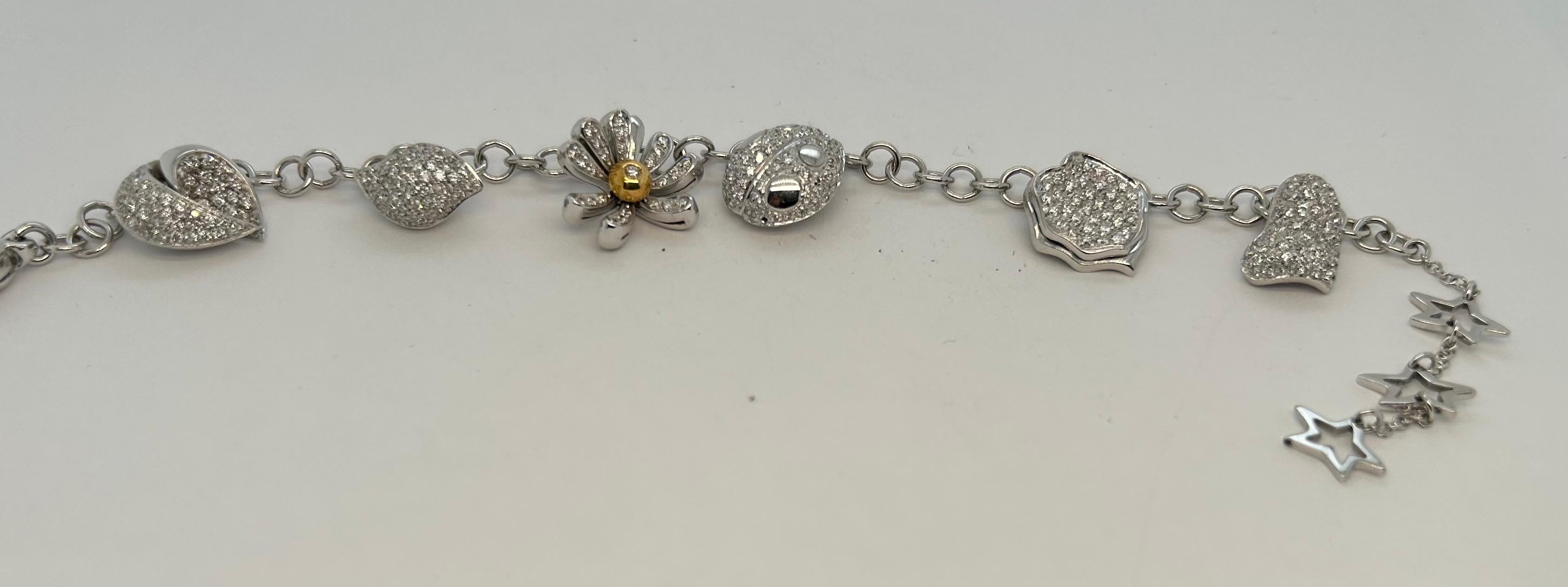 Italian contemporary with fine diamonds 18k WG Charm Bracelet, charms of heart, ladybug, flower and leaf shape, 27.2g, marked 750