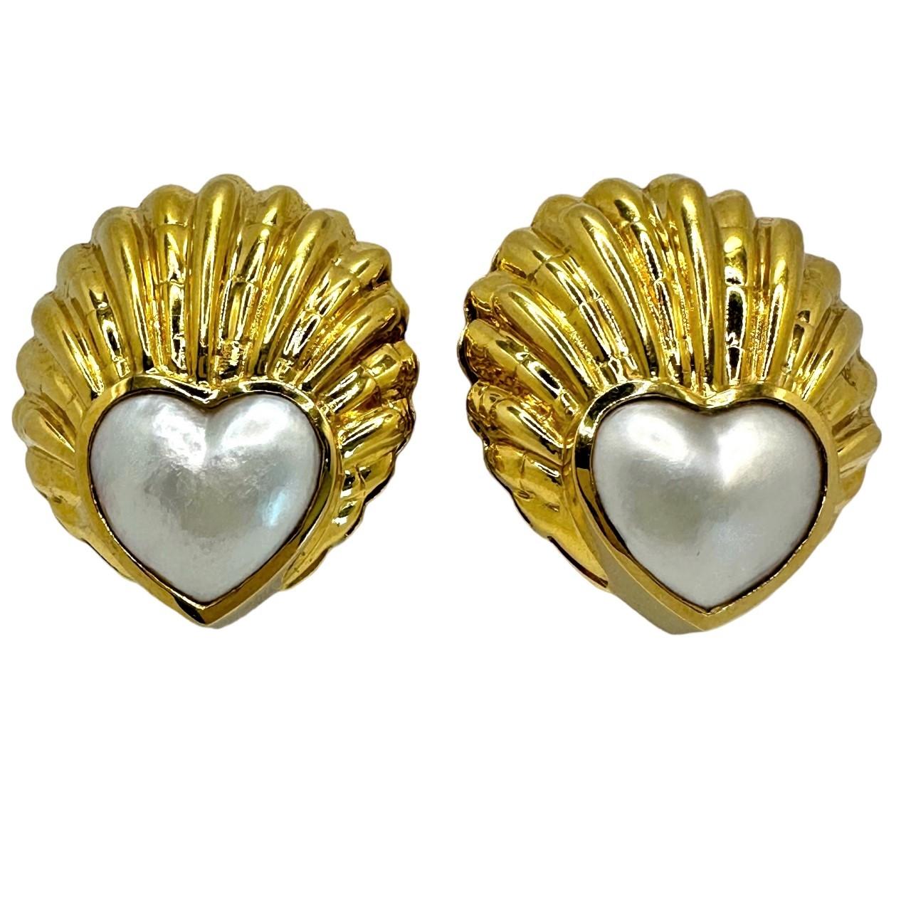 This imaginative pair of very well crafted 18k yellow gold seashell motif earrings are bezel set with two heart shaped Mabe pearls, each measuring 17mm x 17mm. Great attention has been paid to detail in the crafting of the gold shell motifs. The