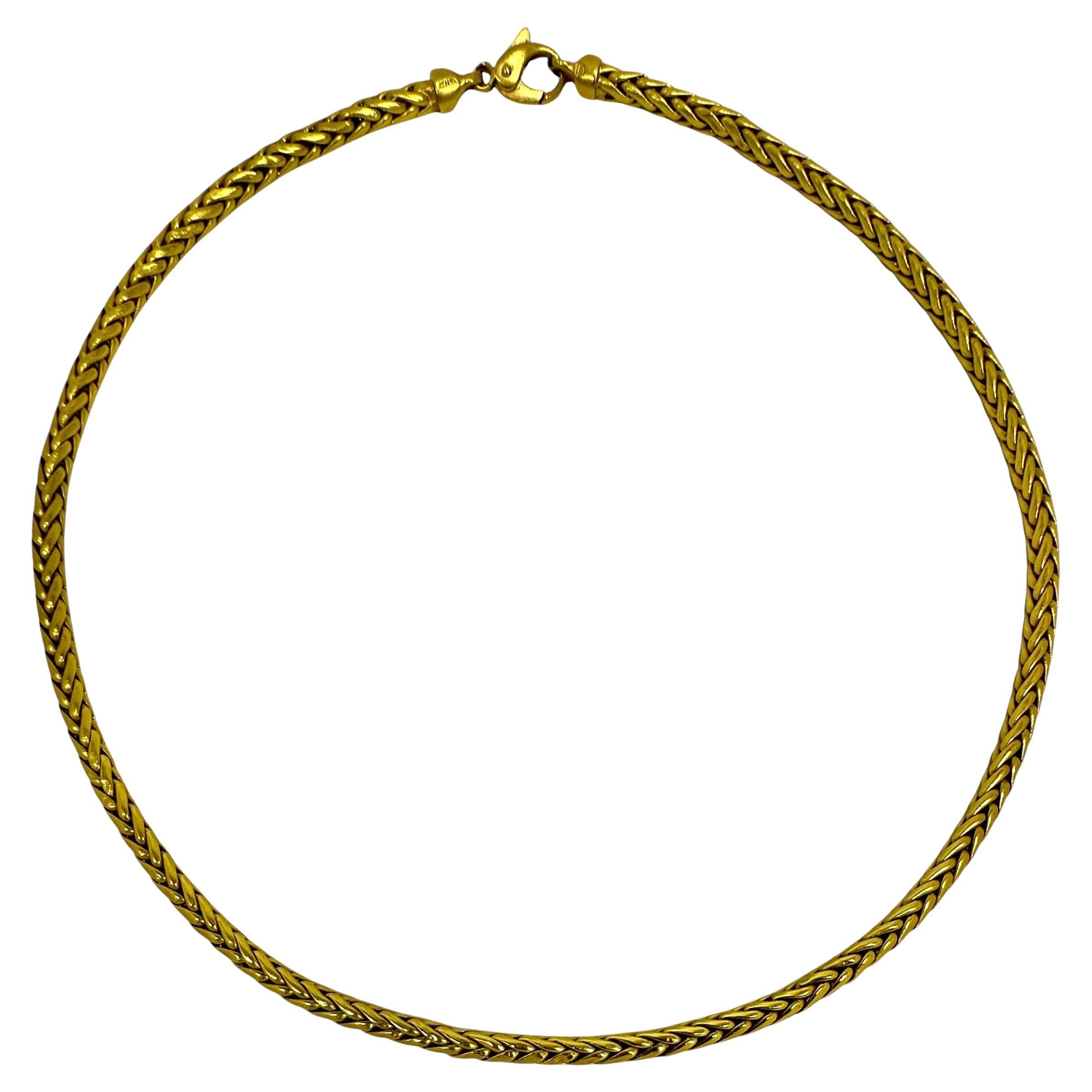 This stylish choker length 18K yellow gold braided/round wheat link necklace by the Italian firm Herco, is a staple to have in any woman's jewelry collection. It can be worn alone or used as an excellent vehicle to hang pendants from. The