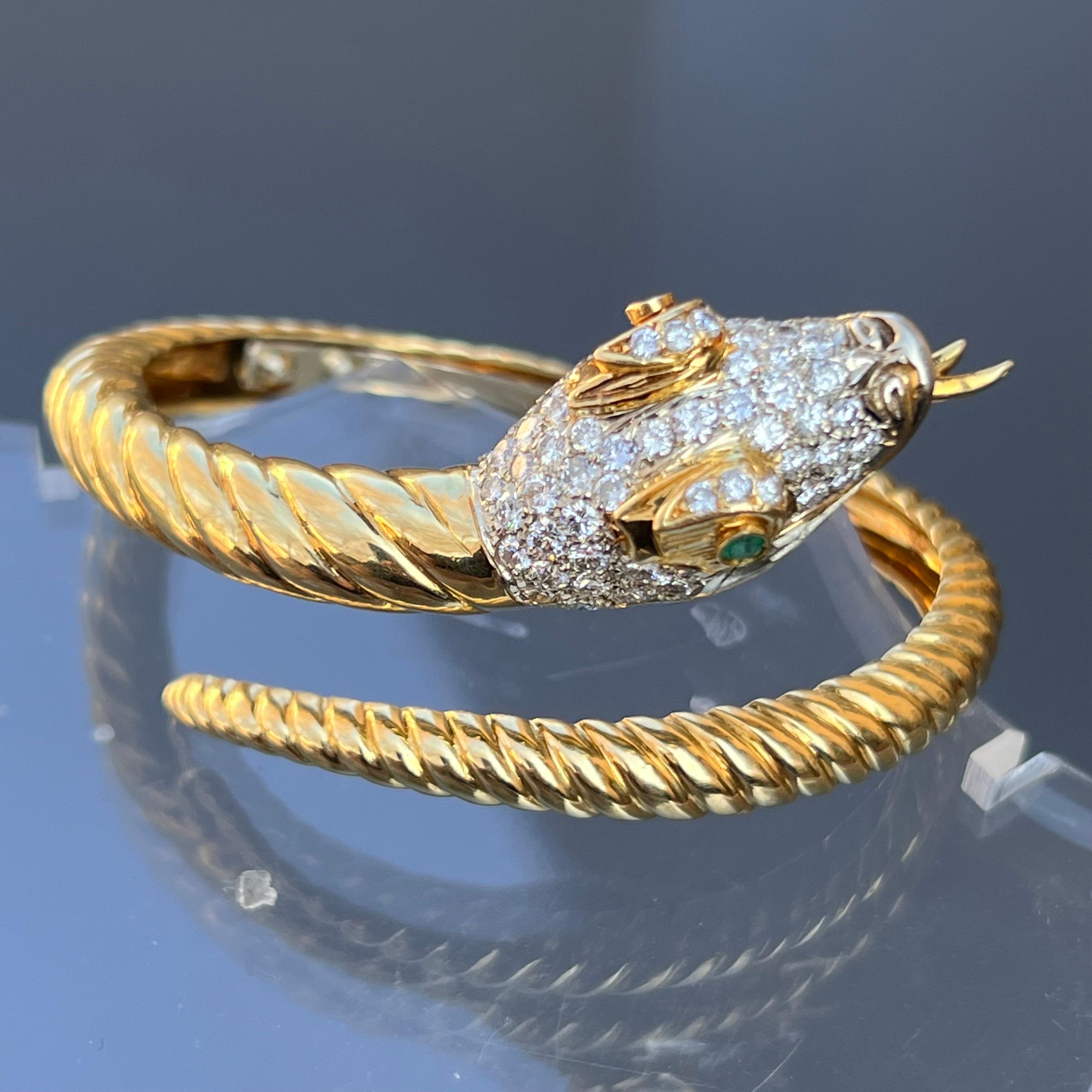 OUTSTANDING heavy vintage  solid 18kt gold snake hinged bangle/bracelet  with head covered with fifty six prong set, round cut diamonds and 2 bezel emerald eyes . Snake body is ribbed with tongue sticking out .
marked 18kt Italy
Dates :