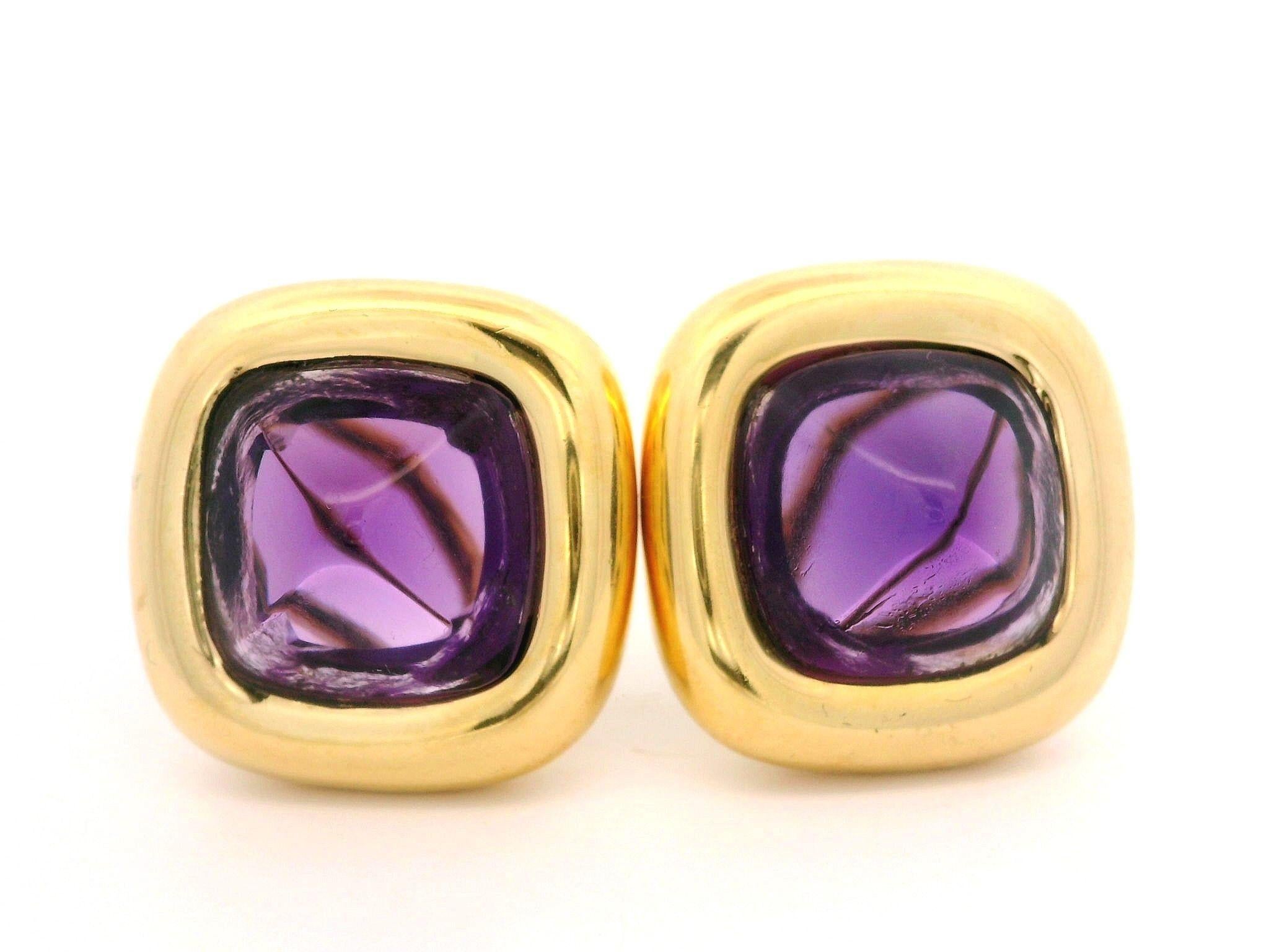 --Stone(s):--
(2) Natural Genuine Amethysts - Sugarloaf Cut - Bezel Set -High Quality - Deep Purple Color - 12.3x12.3mm (approx.)

Material: Solid 18k Yellow Gold
Weight: 20.42 Grams
Backing: Post Backs w/ Omega Closures (Pierced ears are