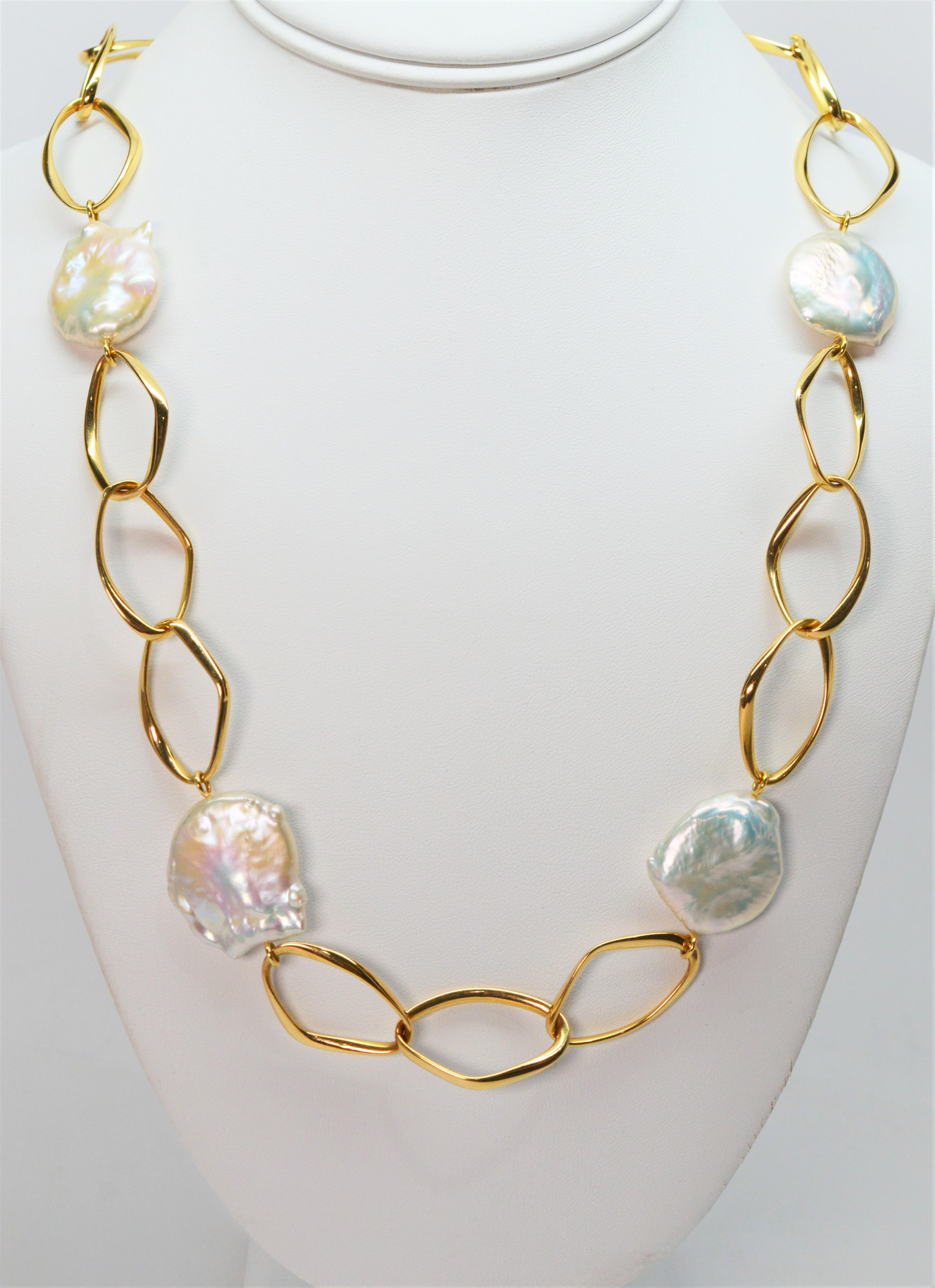 Two bold elements, equally complementary, give this bright and airy chain necklace its fresh modern look. The contemporary oval shaped 3/4 x 1 inch chain links made of highly polished eighteen karat 18k yellow gold boldly accent the five natural