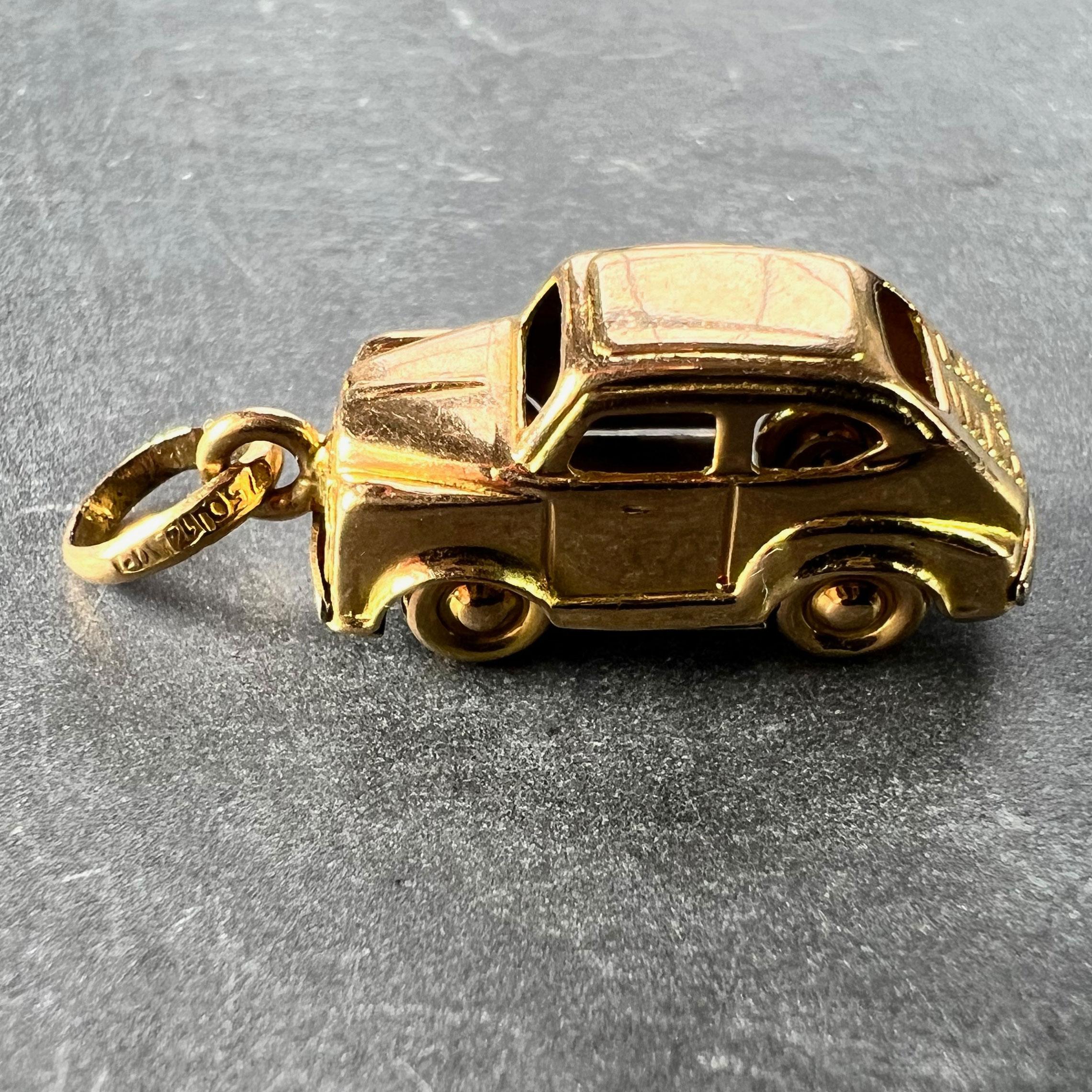 An Italian 18 karat (18K) yellow gold charm pendant designed as a saloon car with moving wheels. Stamped 18 for 18 karat gold to the base, the jump ring marked 750 for 18 karat gold and 14VA for Italian manufacture.

Dimensions: 2.2 x 0.8 x 0.9 cm