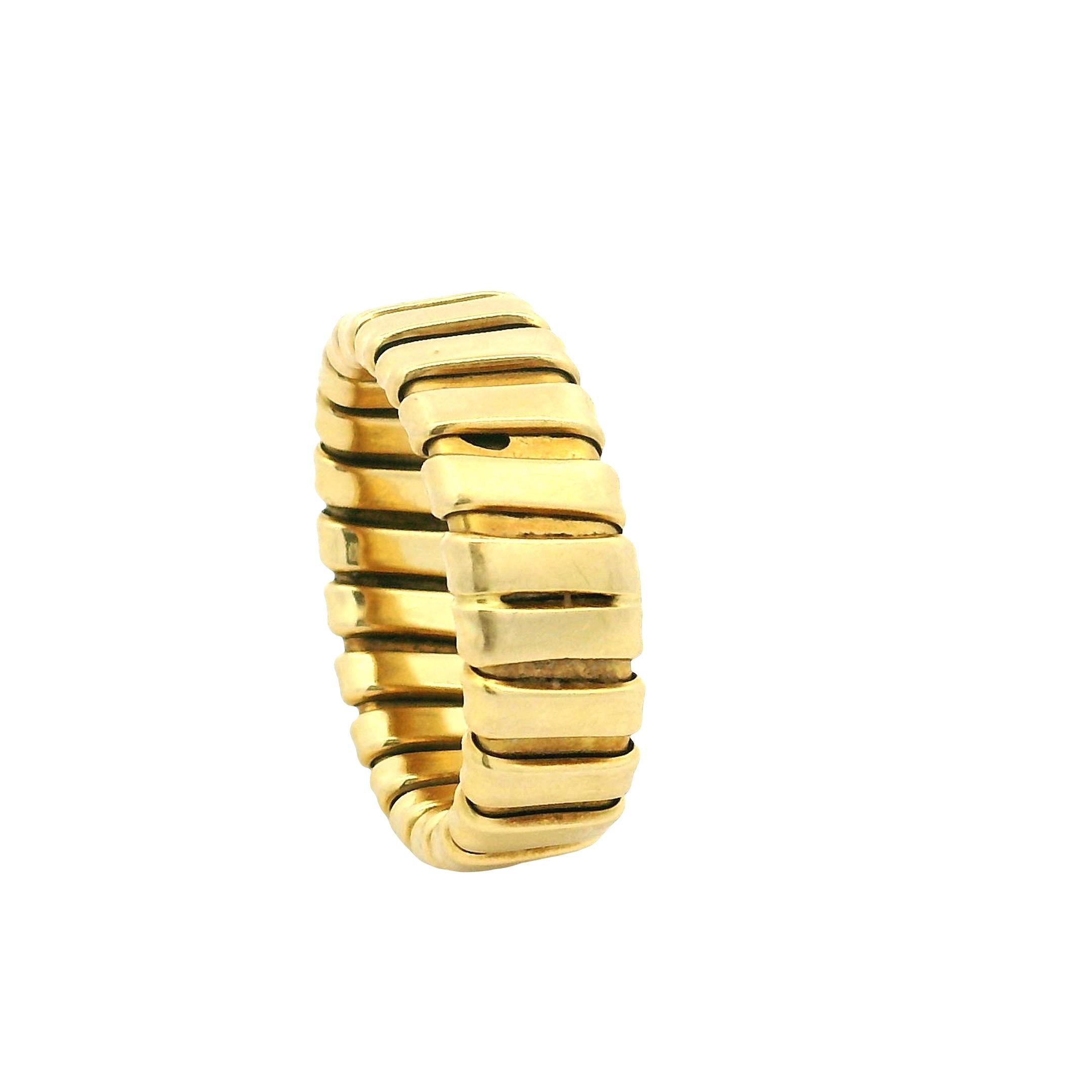 Raffinato esempio di artigianato italiano, questo anello vintage in oro giallo 18 carati presenta l'iconico design tubogas, noto per la sua fluidità, comodità e sobria eleganza. Con un peso di 6,67 grammi, questa fascia flessibile è composta da