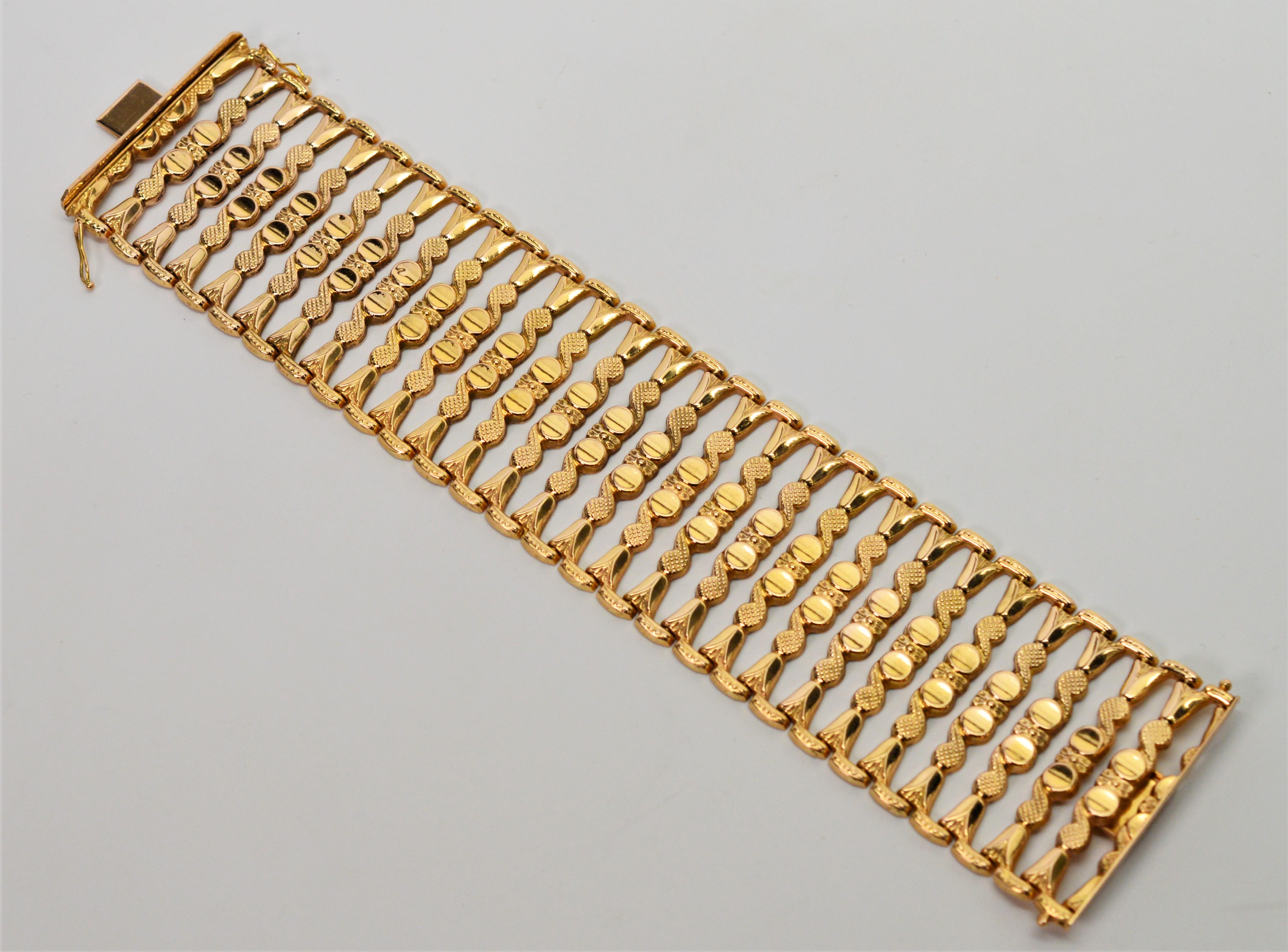 Distinctive, this striking eighteen carat 18K yellow bracelet is sure to be a prominent piece in your jewelry wardrobe. This hand made Italian 1950's  ladder link bracelet measures a substantial 1-3/4 inches wide.  Twenty seven flexible decorative